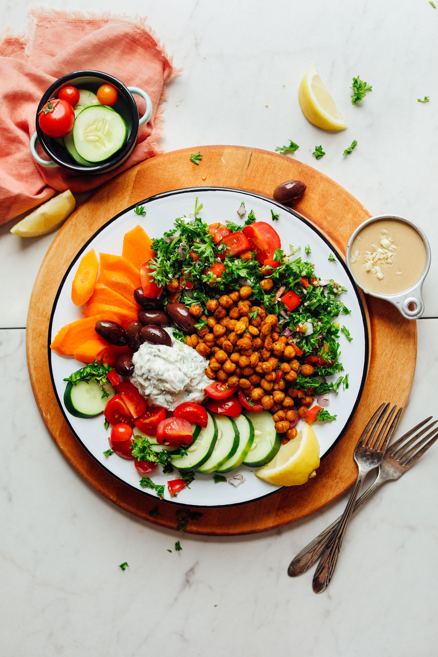Plate filled with our Vegan Greek Bowl with Crispy Chickpeas, Vegan Tzatziki, and Veggies