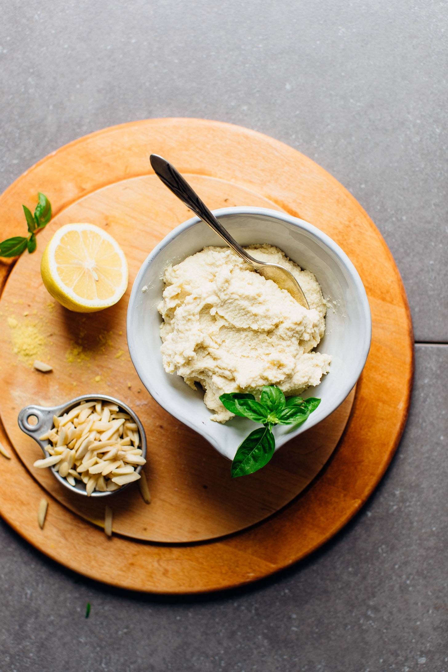 Wooden cutting board with a bowl of WHIPPED Vegan Ricotta Cheese
