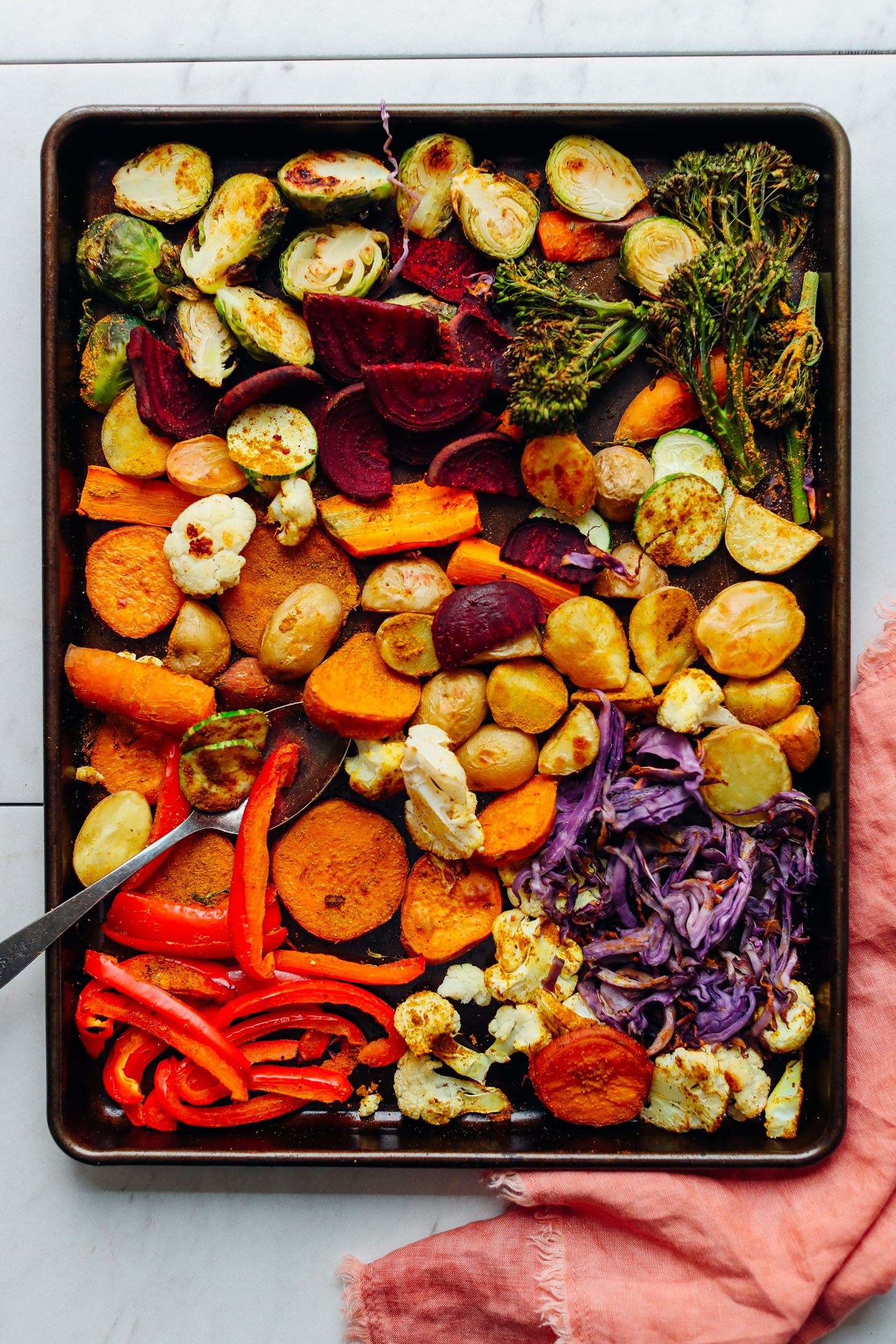 Baking tray filled with a bounty of freshly roasted vegetables