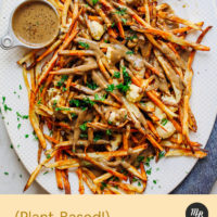 Platter of Vegan Poutine topped with fresh parsley