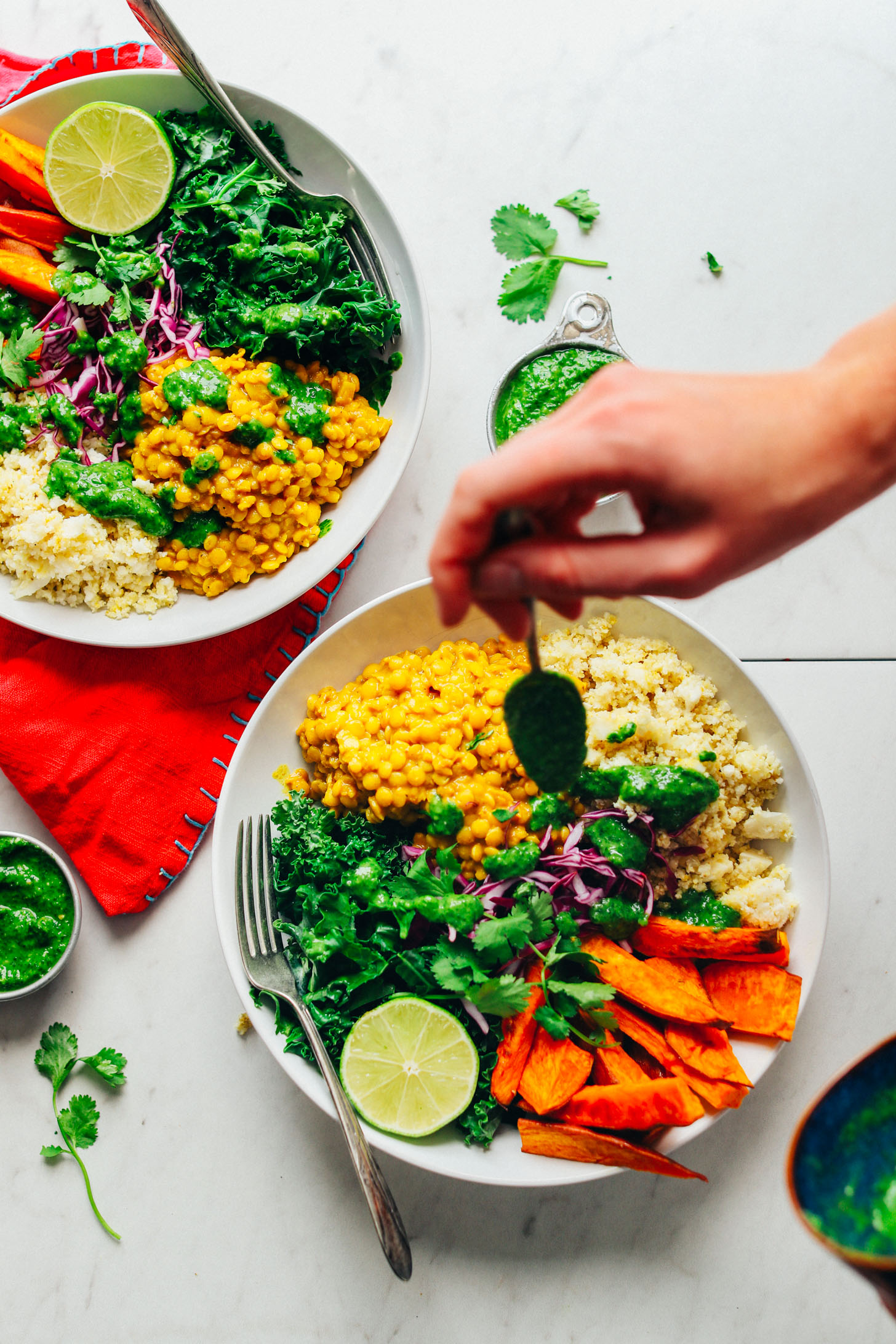 Drizzling cilantro chutney over our gluten-free vegan Curried Golden Lentil & Sweet Potato Bowl
