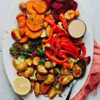 Platter of Oil-Free Roasted Vegetables with a bowl of tahini and a lemon half