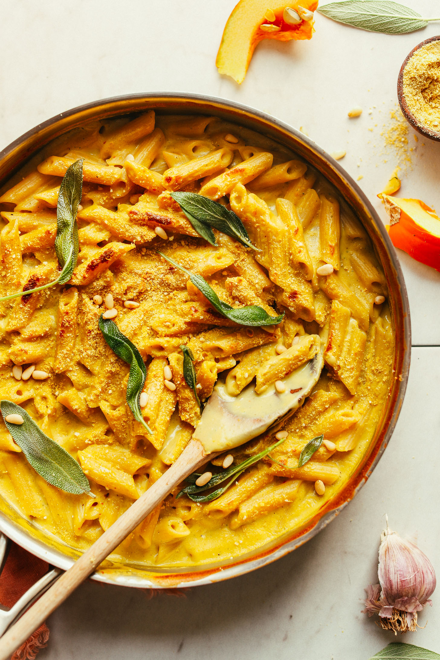 Saute pan with Pumpkin Mac 'n' Cheese topped with fresh sage leaves