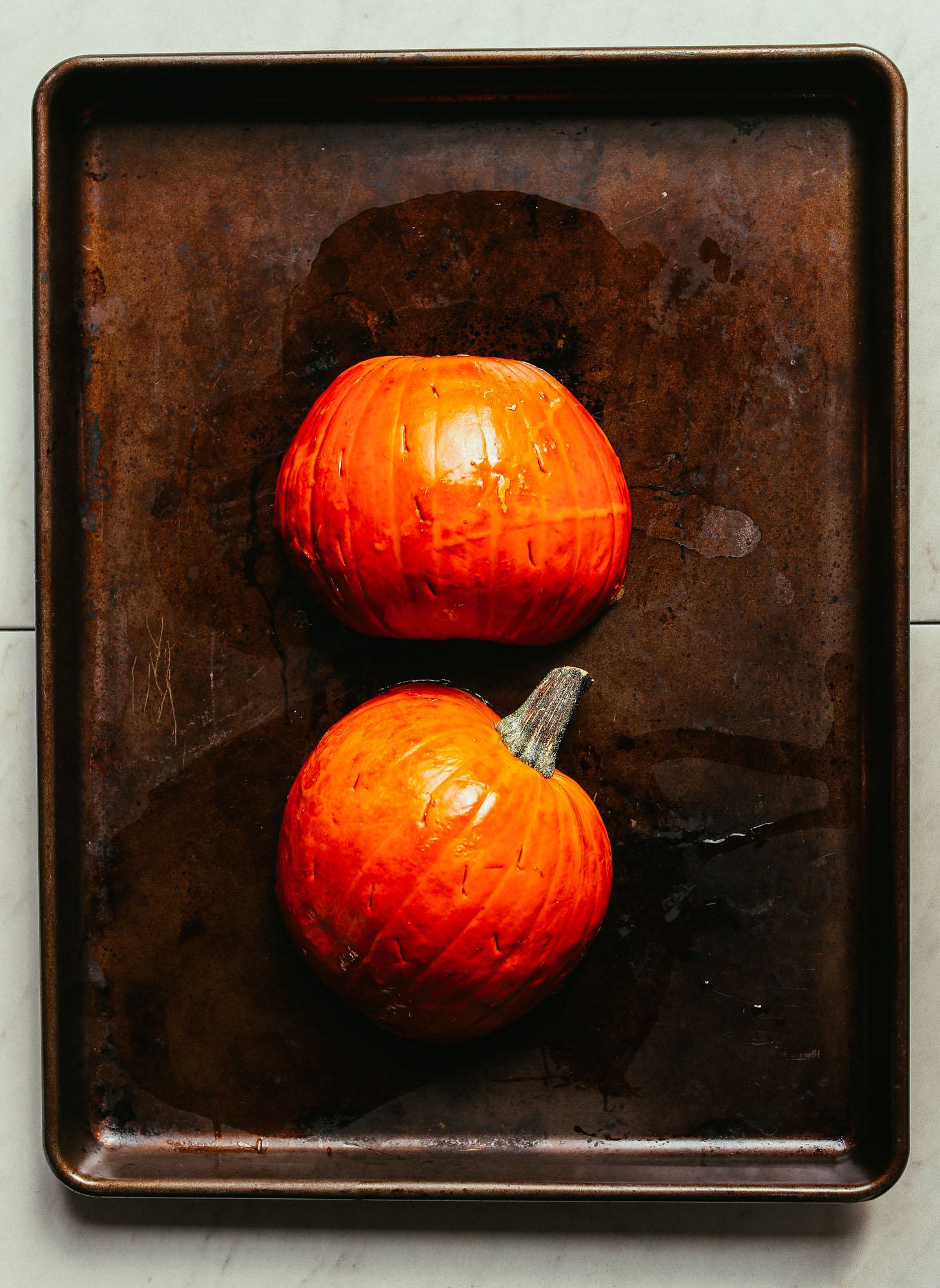 Adorable pumpkins on a baking sheet for making gluten-free vegan Pumpkin Mac 'n' Cheese