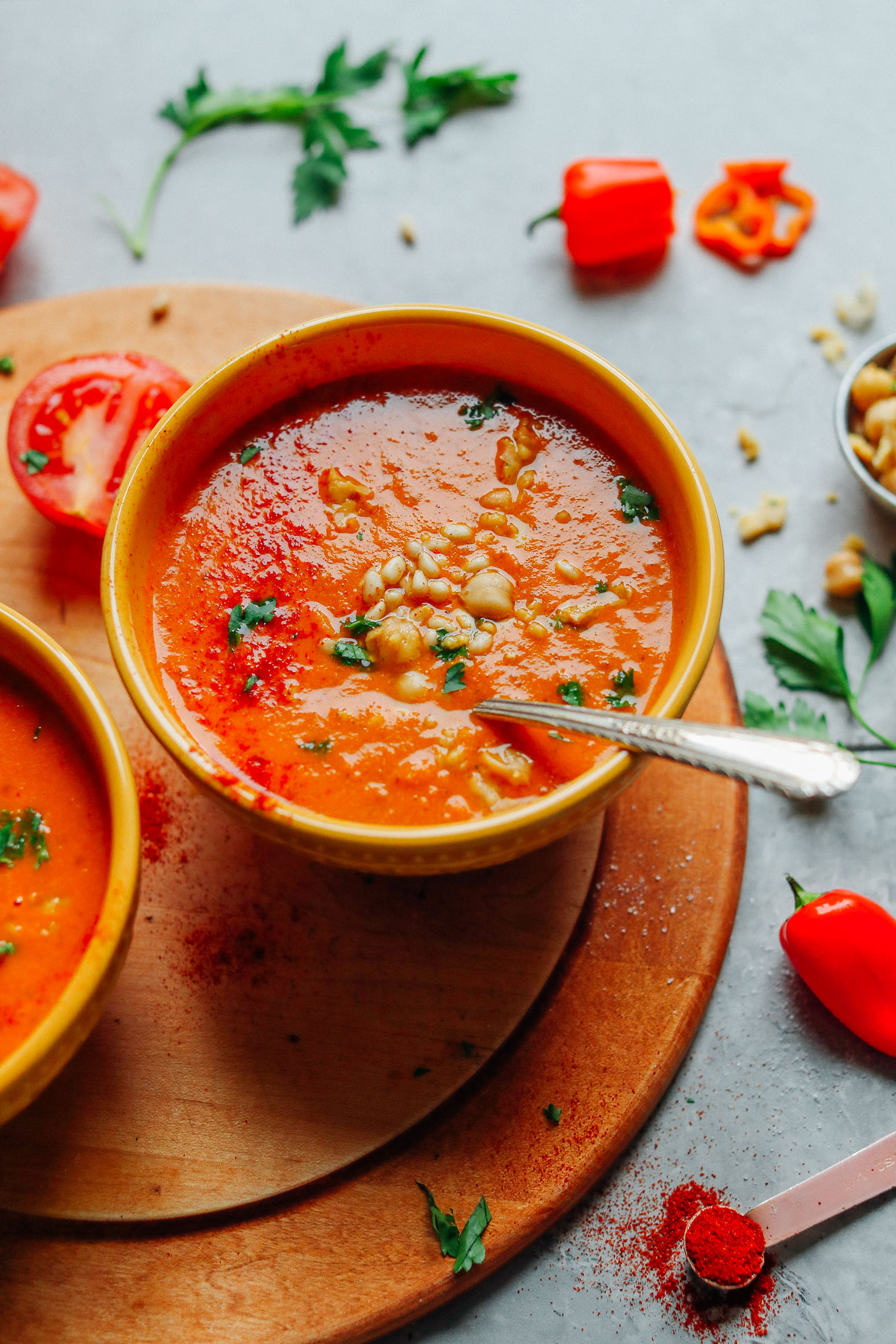 Close up shot of rich and flavorful Romesco Soup with Smashed Chickpeas topped with pine nuts