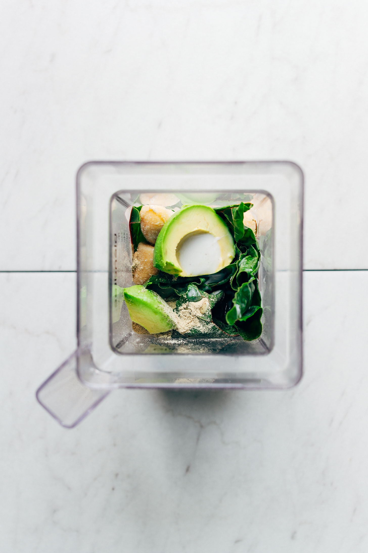 Ingredients for our vegan Avocado Green Smoothie recipe in the blender