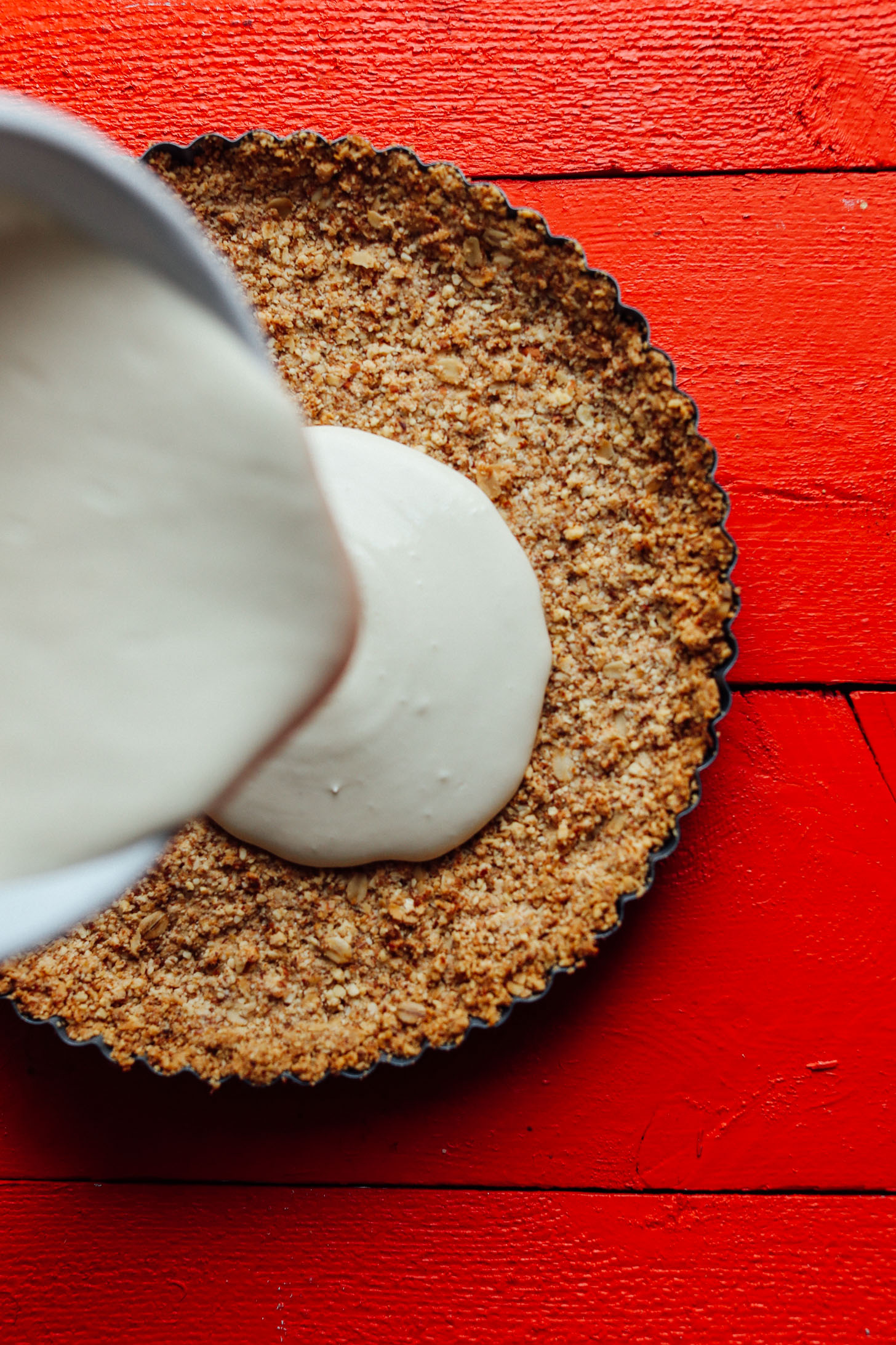 Pouring the filling into the crust for Caramel Apple Tart