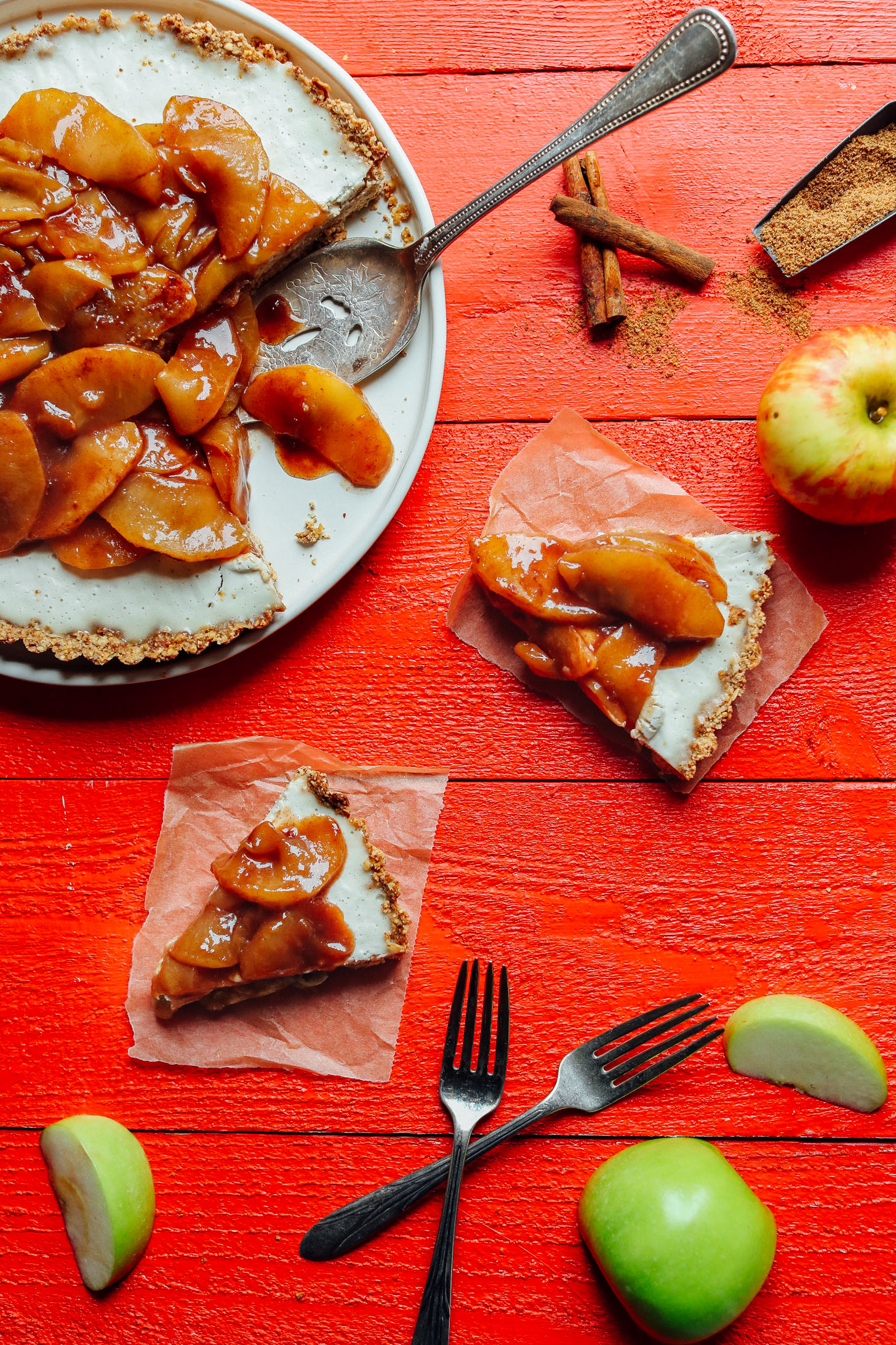 Slices of gluten-free, vegan Caramel Apple Tart on squares of parchment paper