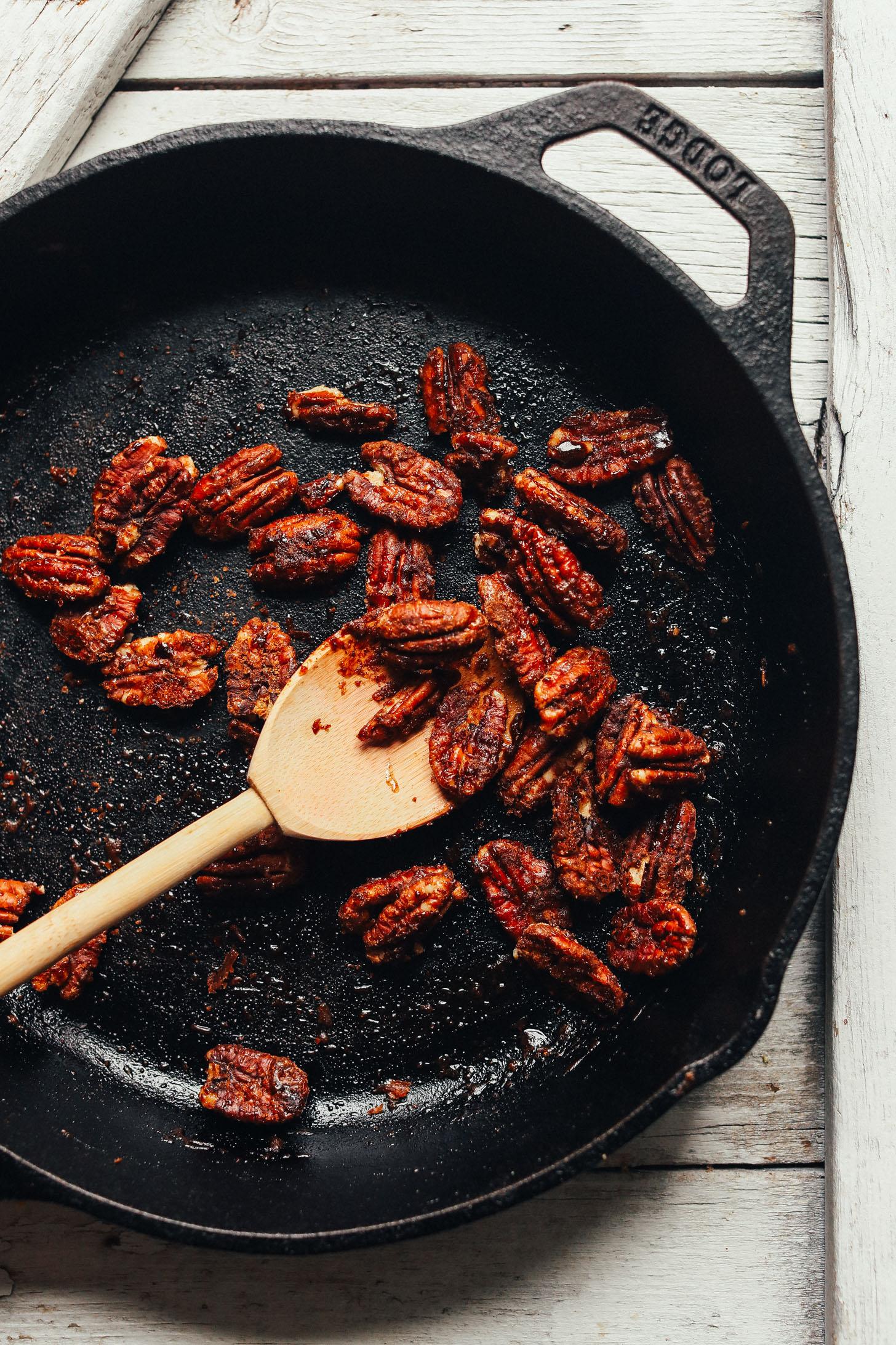Cast iron skillet with freshly toasted candied pecans for our Herbed Green Salad with Crispy Chickpeas and Cranberry Vinaigrette