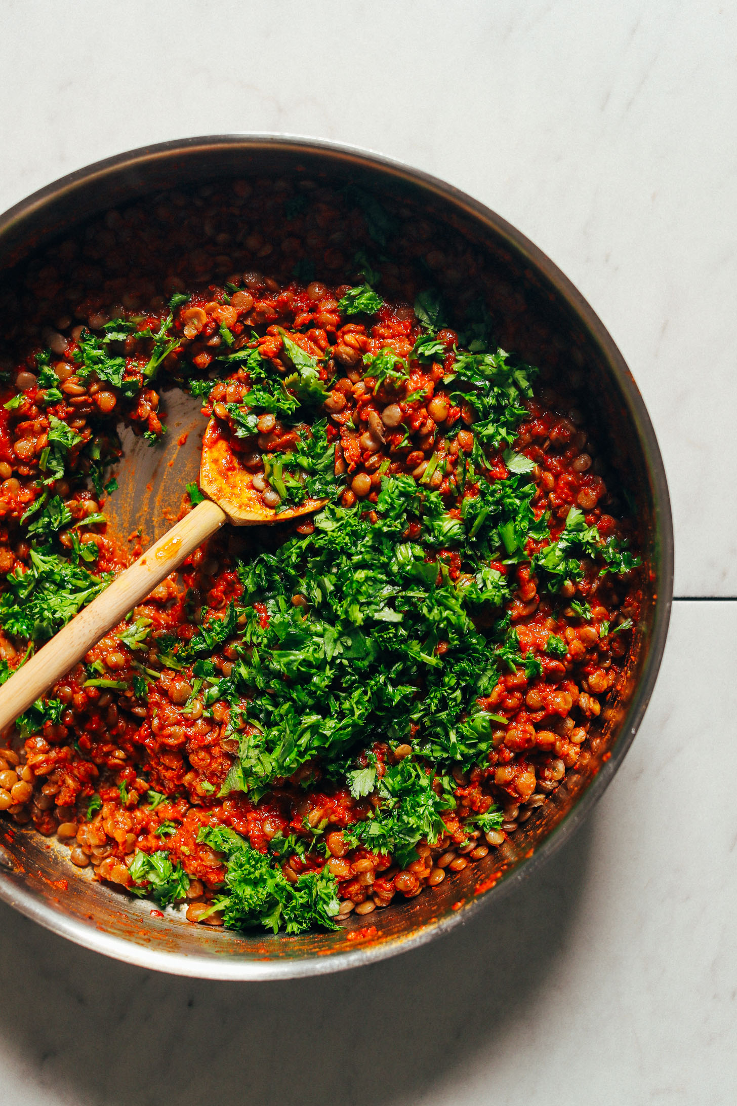 Large saute pan with Moroccan-Spiced Lentils garnished with fresh parsley and cilantro