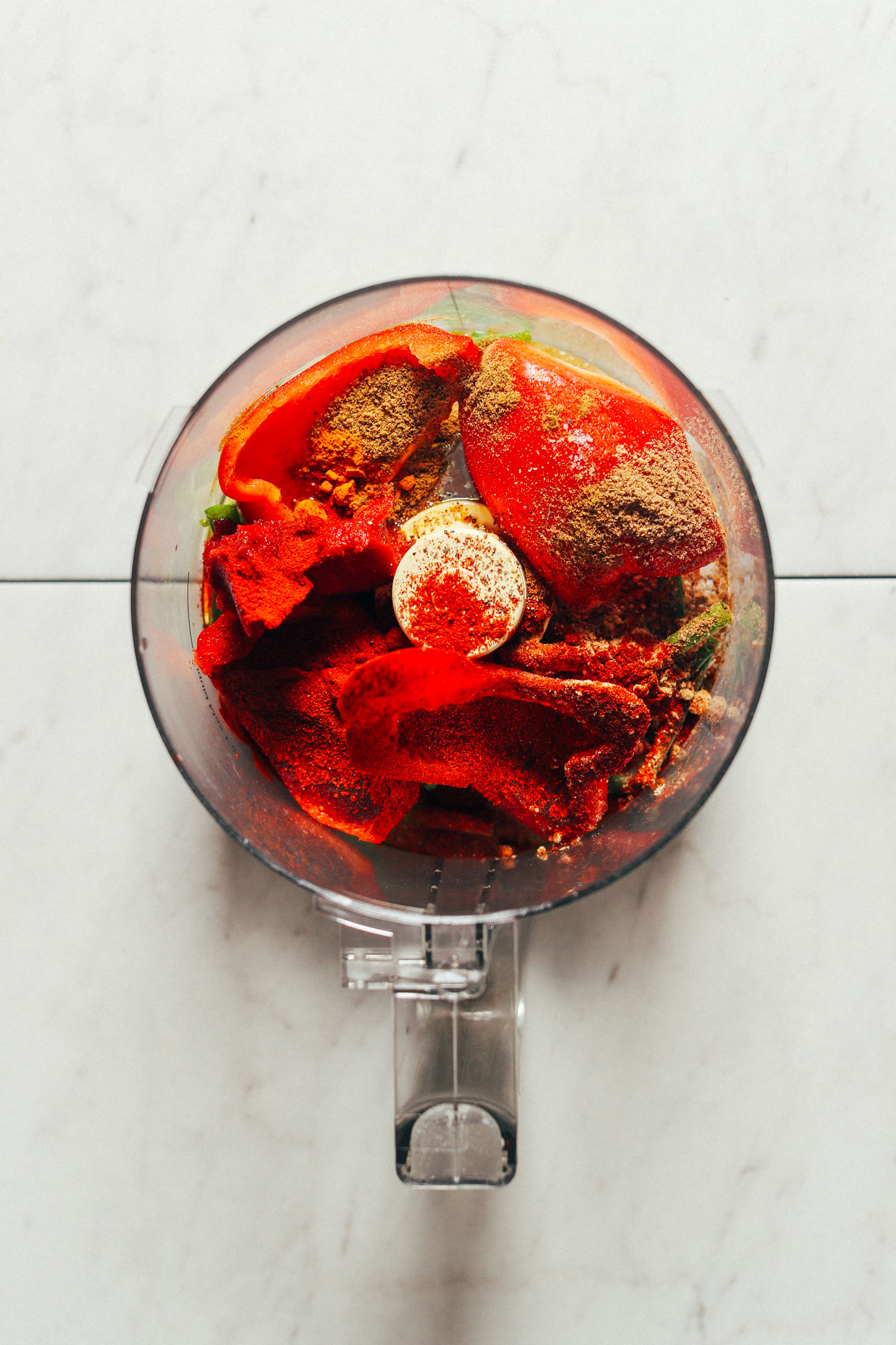 Food processor filled with vegetables for making gluten-free and vegan Moroccan-Spiced Lentils