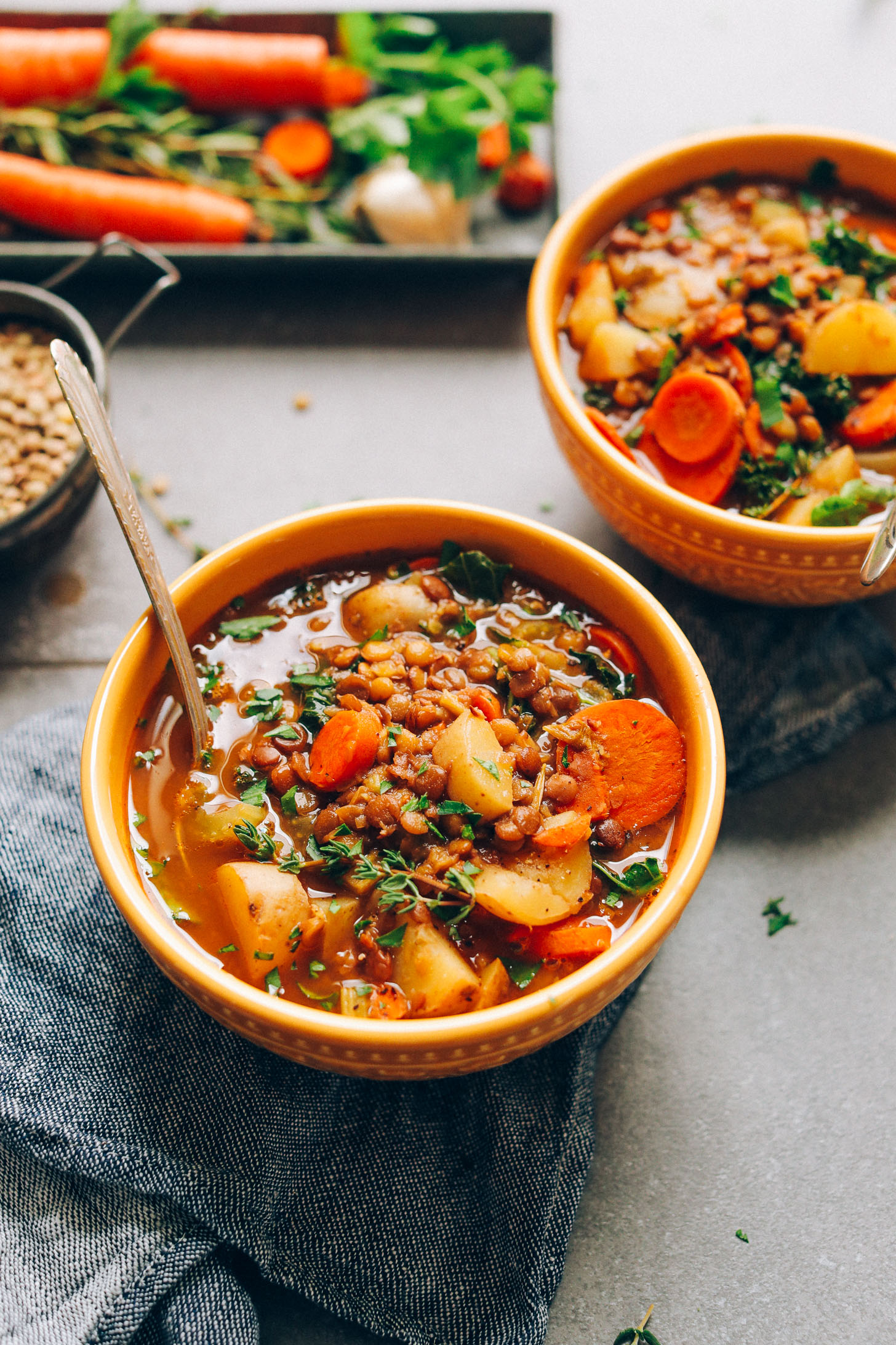 Bowls of our Everyday Lentil Soup recipe garnished with sprigs of fresh thyme