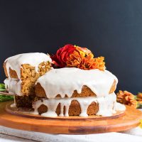 Removing a slice of gluten-free vegan Pumpkin Cake from a cutting board