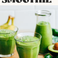 Creamy avocado banana green smoothies on a cutting board