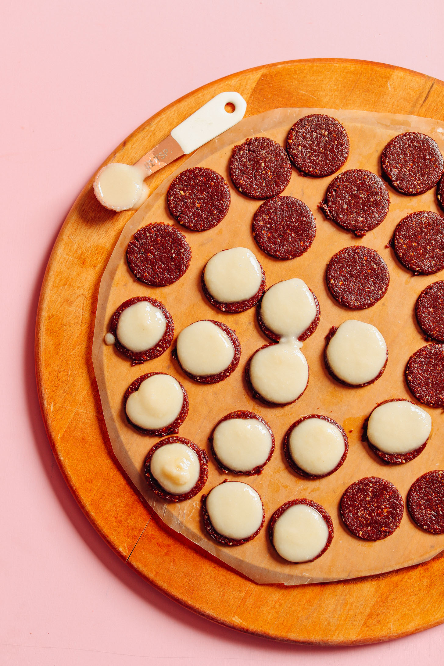 Coconut butter filling on top of half of the gluten-free vegan Raw Oreo Cookies