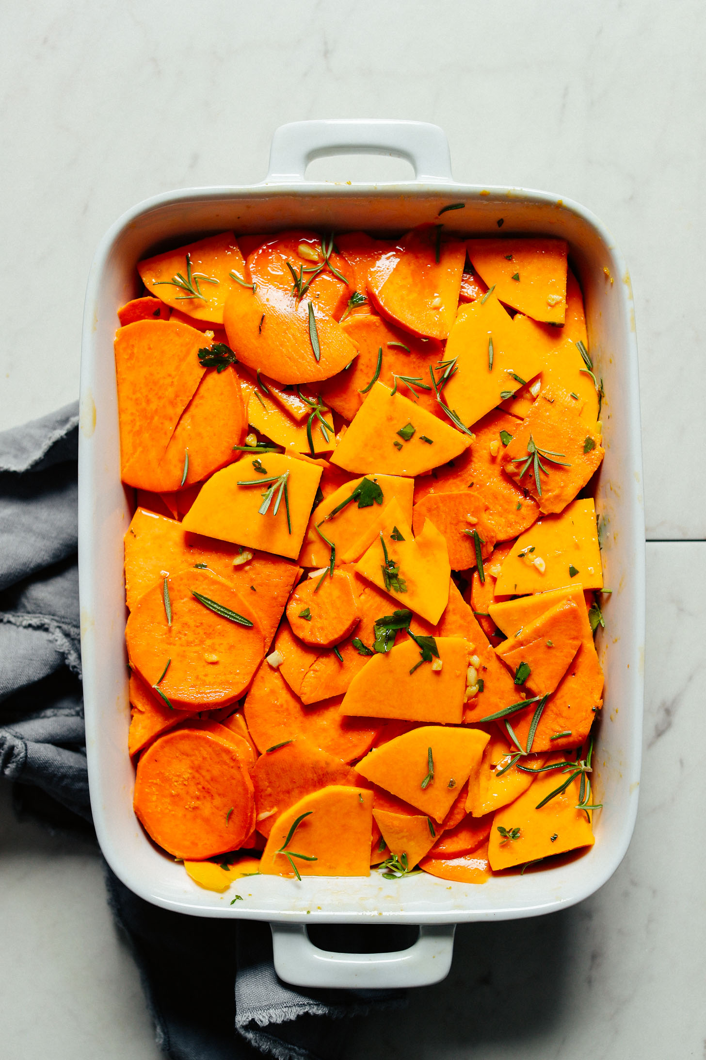 White ceramic baking dish containing a batch of Vegan Sweet Potato Butternut Squash Tortilla