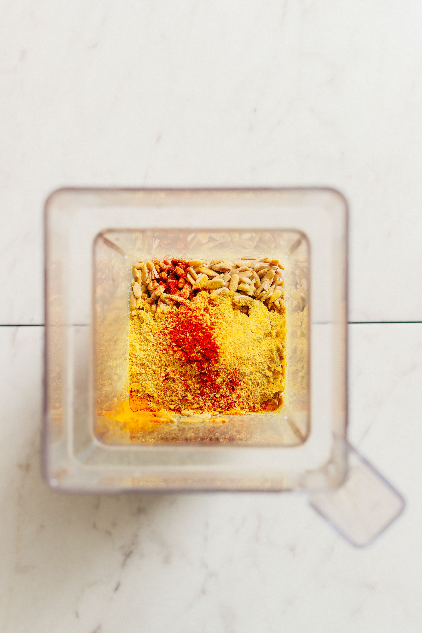 Blender with ingredients for making delicious Sunflower Seed Cheeze