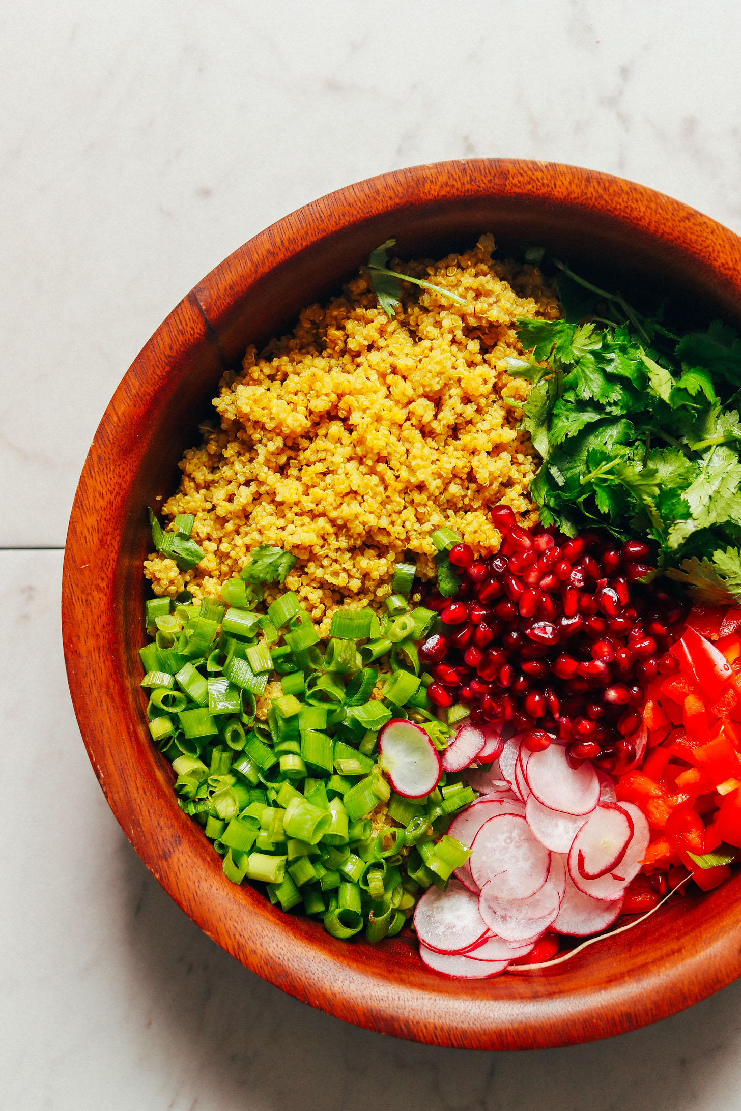 Large wooden salad bowl with Curried Quinoa Salad with vegetables
