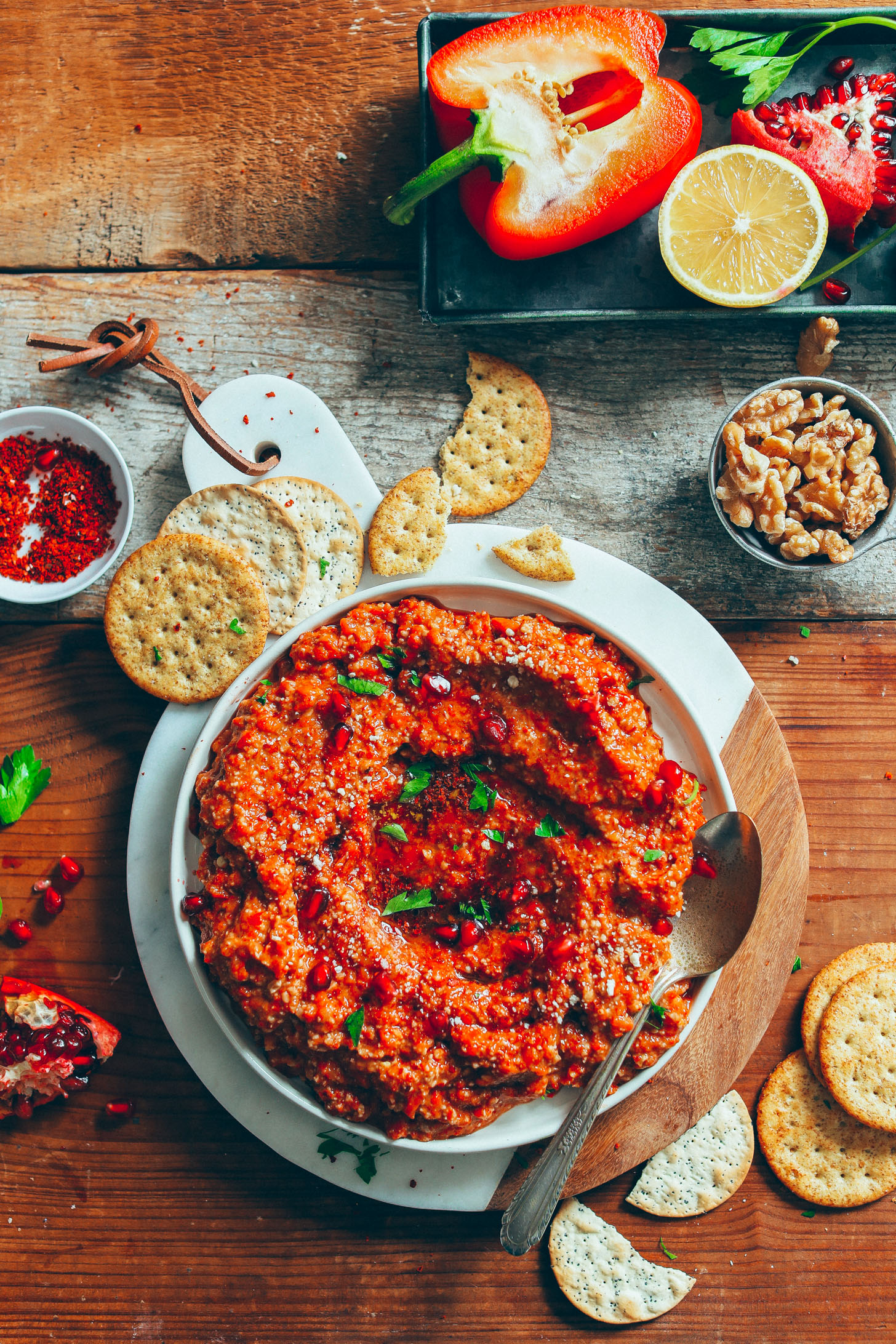 A bowl of Gluten-Free Muhamarra Dip served with gluten-free crackers