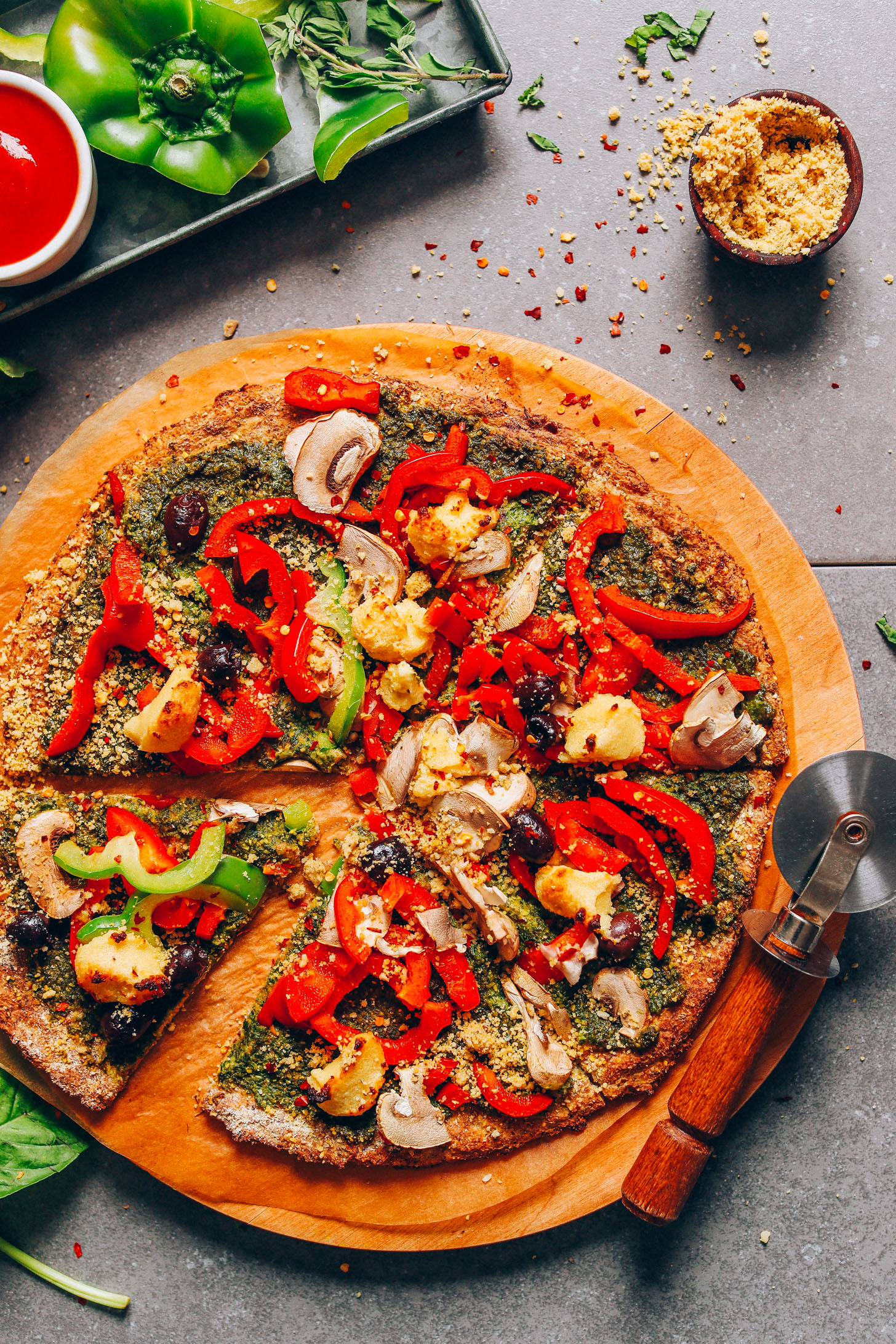 Sliced vegan gluten-free pizza made with a cauliflower crust