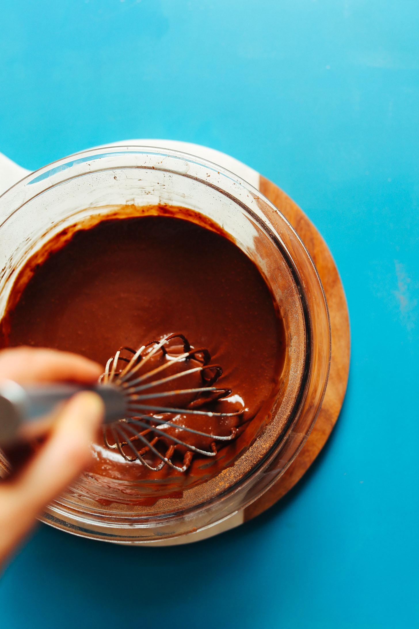 Whisking together warmed cocoa butter, cacao powder, and coconut milk for Vegan Hot Chocolate