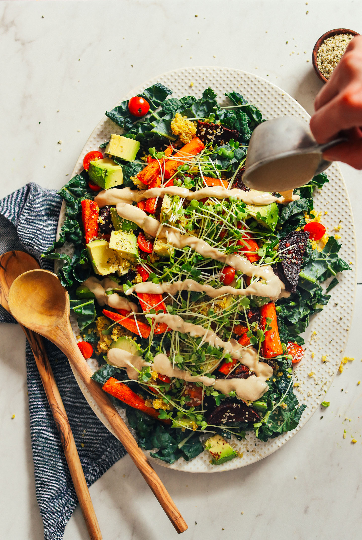 HEALTHY Loaded Kale Salad in just 55 minutes! Roasted and fresh veggies, sprouts, quinoa, and tahini dressing! #dinner #vegan #glutenfree #salad #healthy #minimalistbaker #recipe