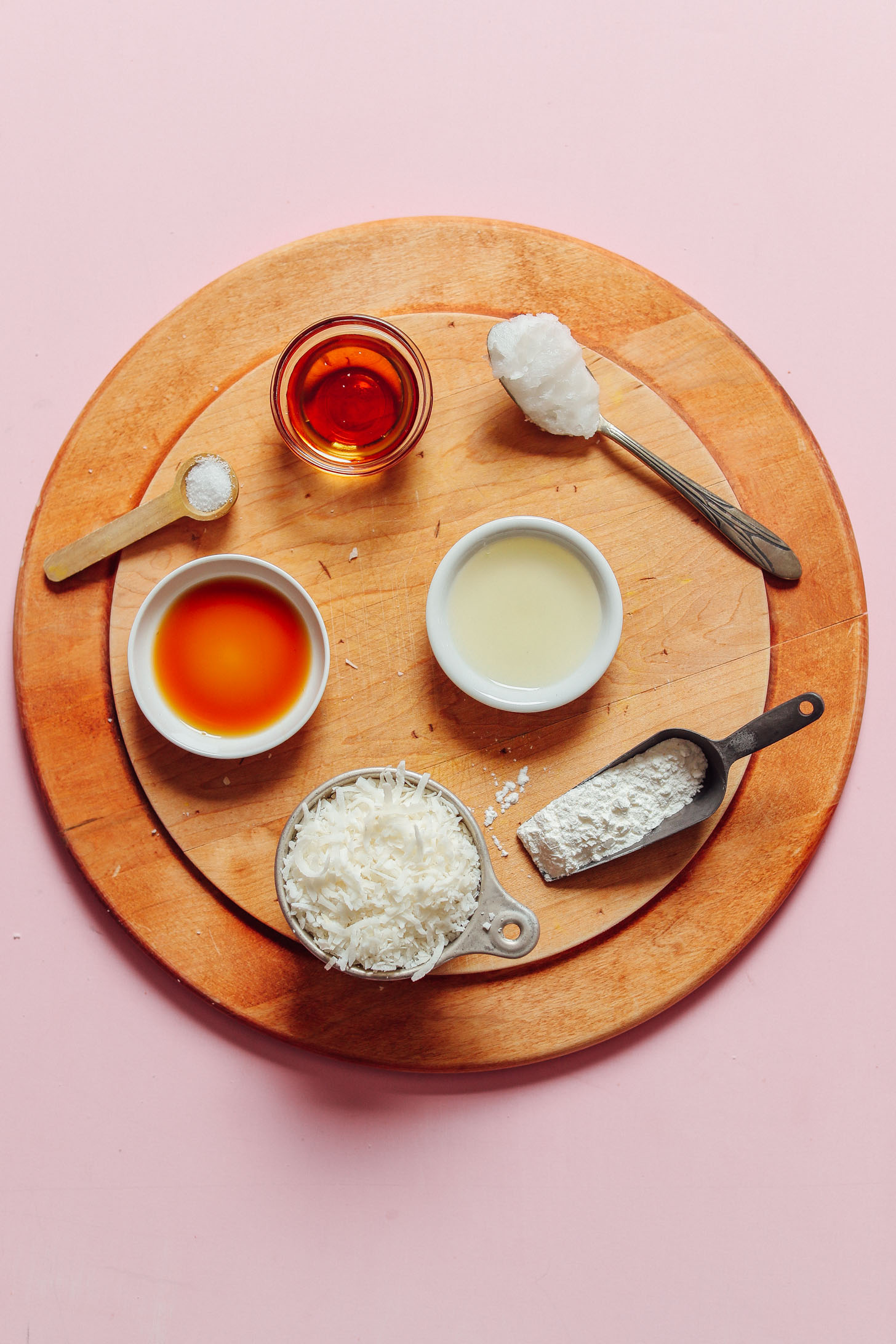 Wood cutting board with ingredients for making our Vegan Coconut Snowball Cookies recipe