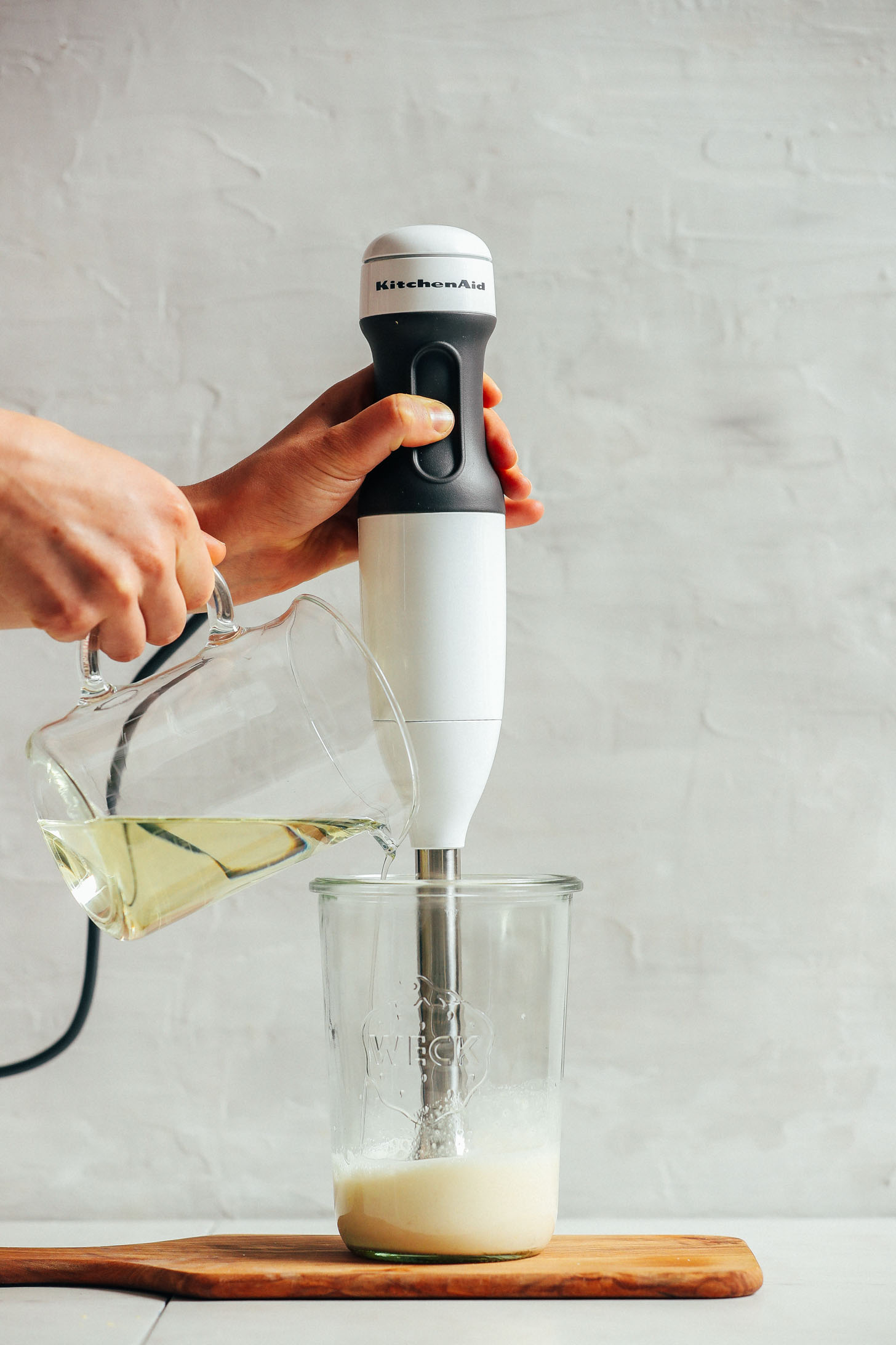 Using an immersion blender to emulsify oil with other ingredients for homemade vegan mayo