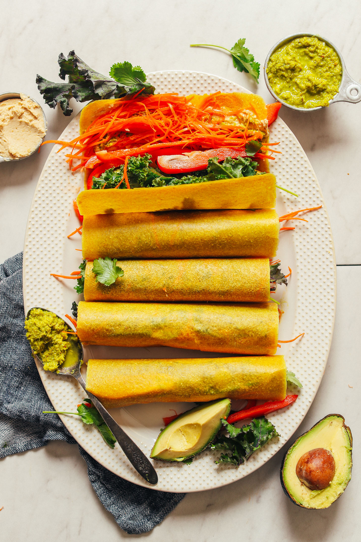 Serving platter full of quick & easy Coconut Wraps with Veggies, Hummus, and Curry Paste