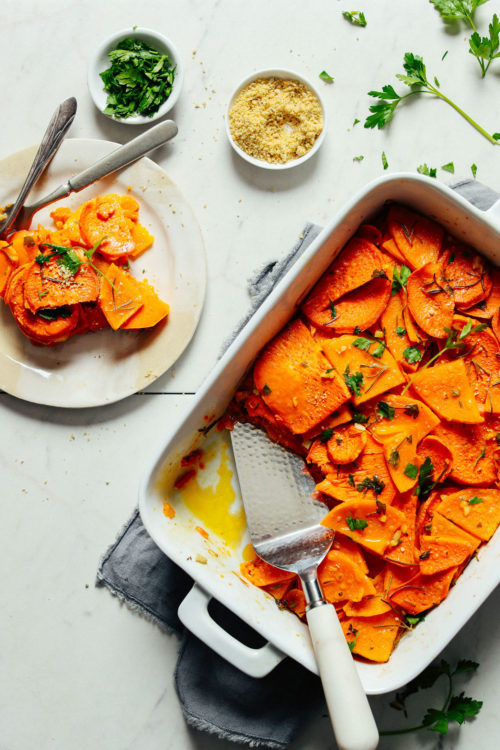A small plate serving of Vegan Sweet Potato Butternut Squash Tortilla placed beside the freshly baked whole dish