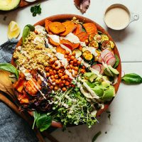 Wooden salad bowl loaded with Abundance Kale Salad