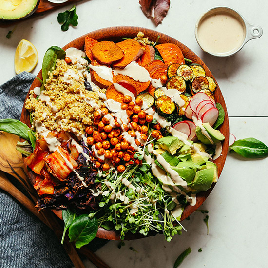 Wooden salad bowl loaded with Abundance Kale Salad