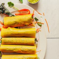 Platter of homemade Vegan Coconut Wraps filled with hummus and vegetables