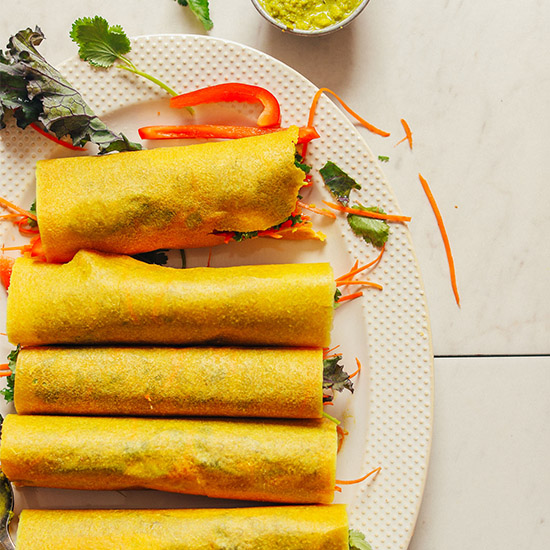 Platter of homemade Vegan Coconut Wraps filled with hummus and vegetables