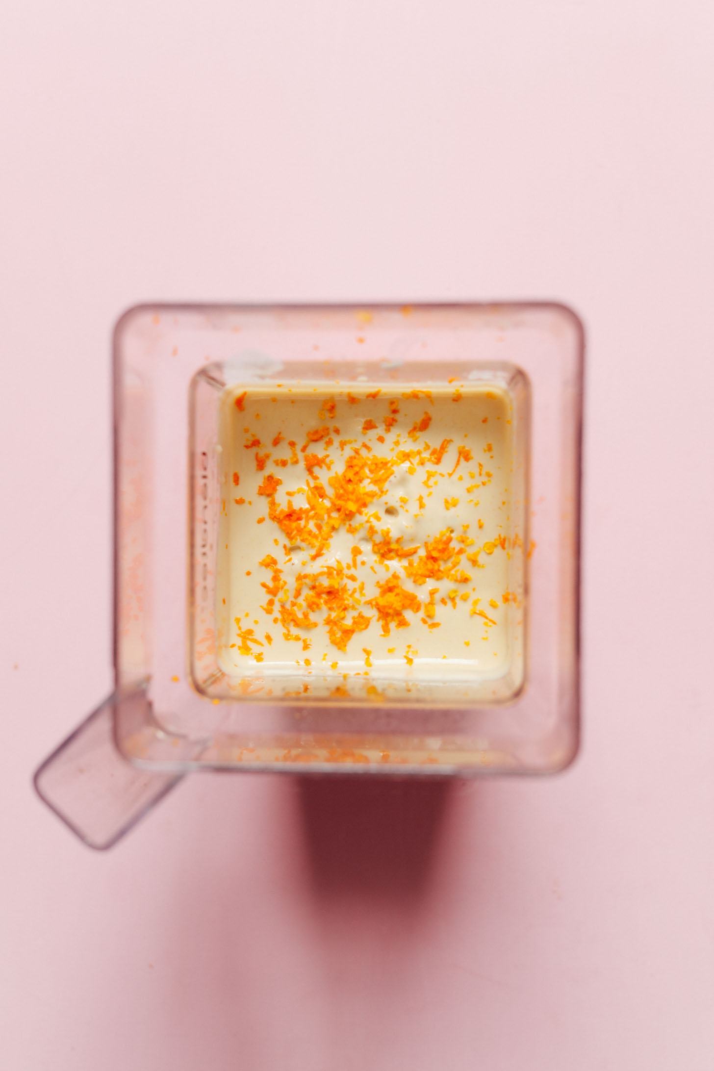 Cheesecake filling ingredients blended up and topped with orange zest for this tangy, naturally sweet, vegan dessert