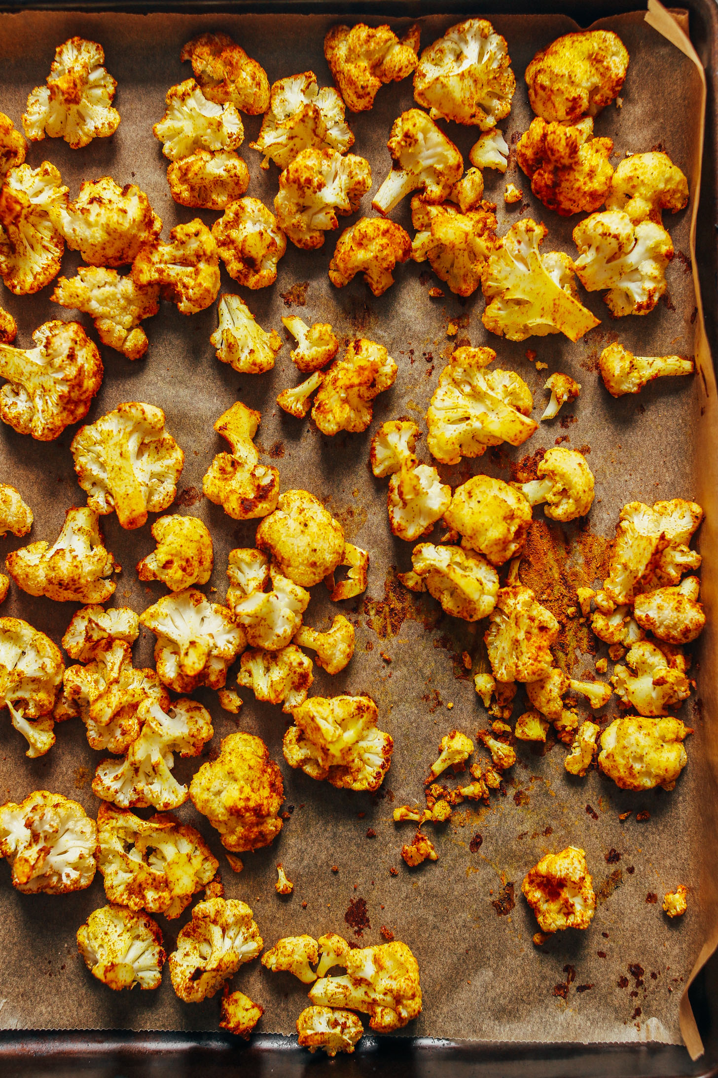 Parchment-lined baking sheet with Curry Roasted Cauliflower fresh from the oven