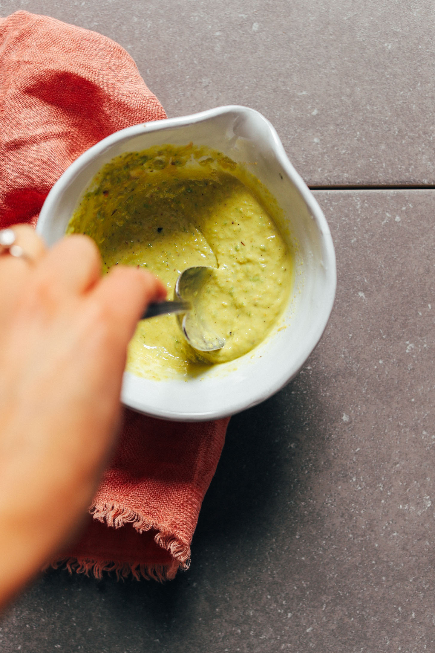Stirring up super flavorful Green Curry Tahini Dressing for this healthy kale salad