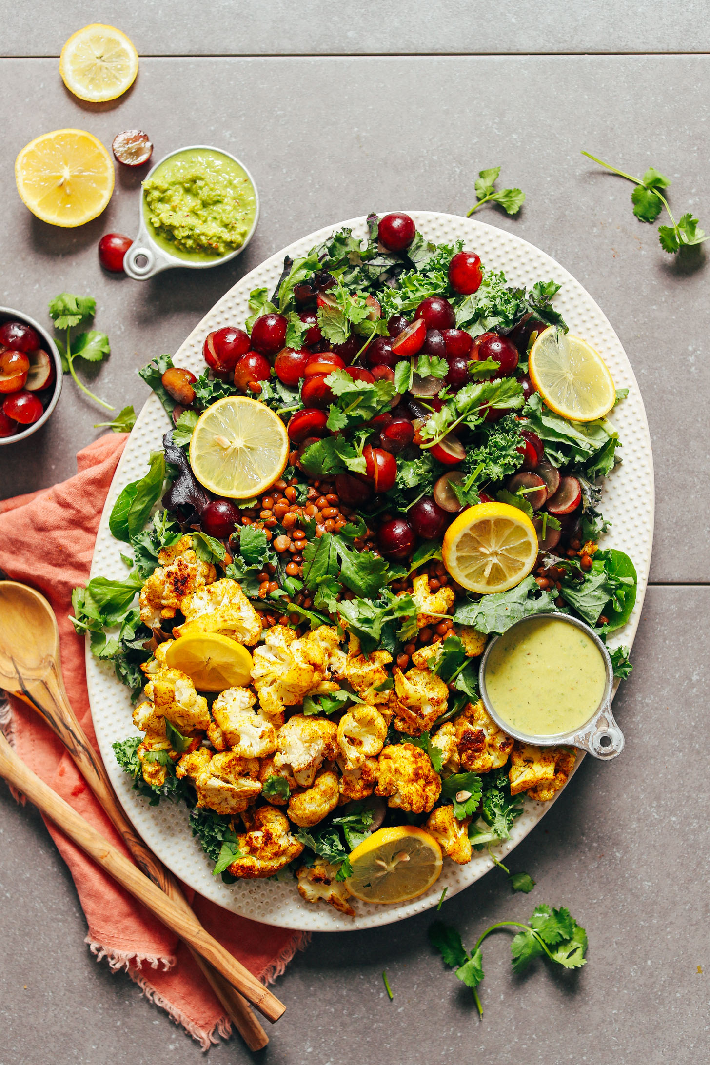 A delicious platter of plant-based and gluten-free Kale Salad with Grapes, Lentils and Curry Roasted Cauliflower