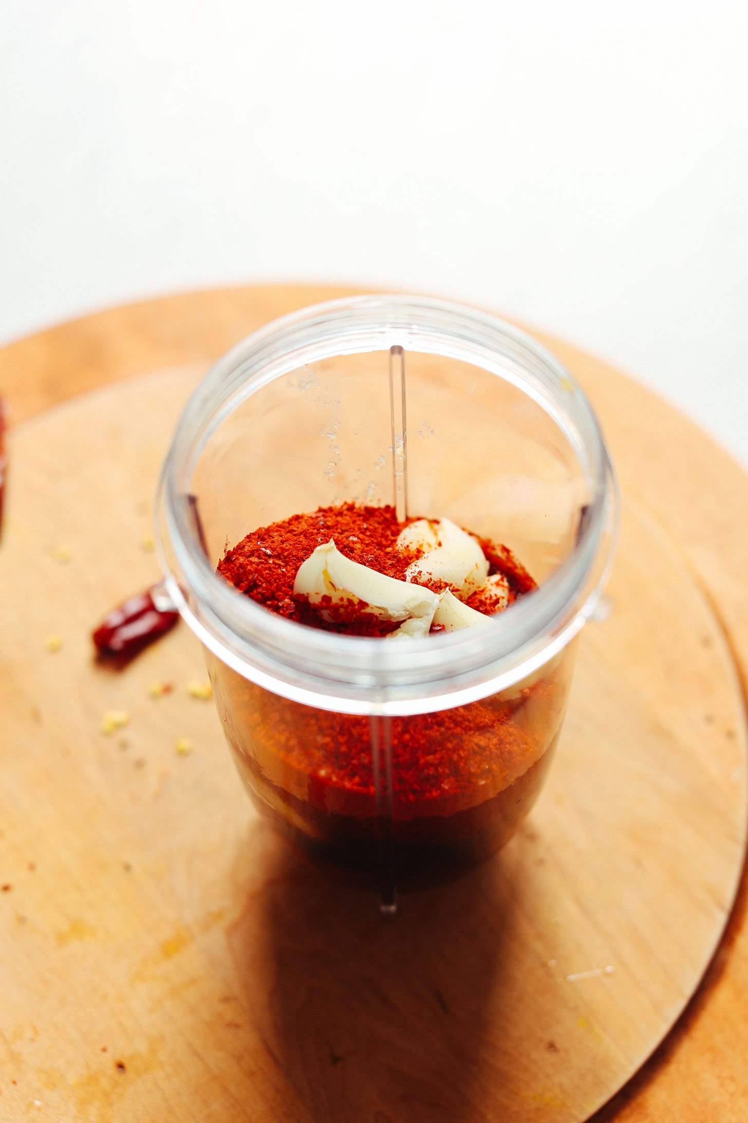 Small blender filled with Korean chili flakes and garlic