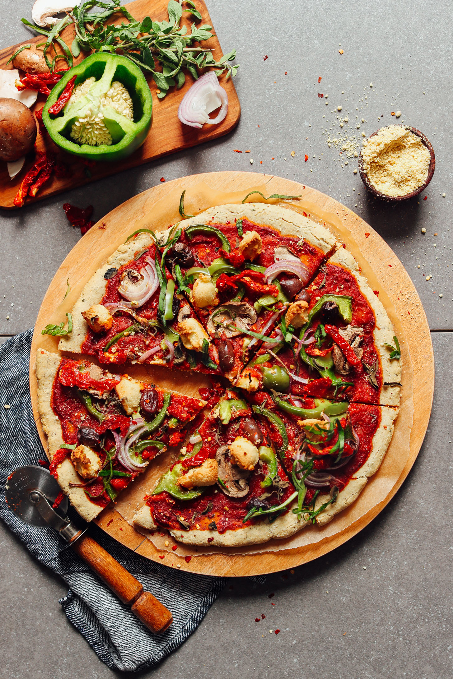 A whole gluten-free and vegan pizza cut into slices