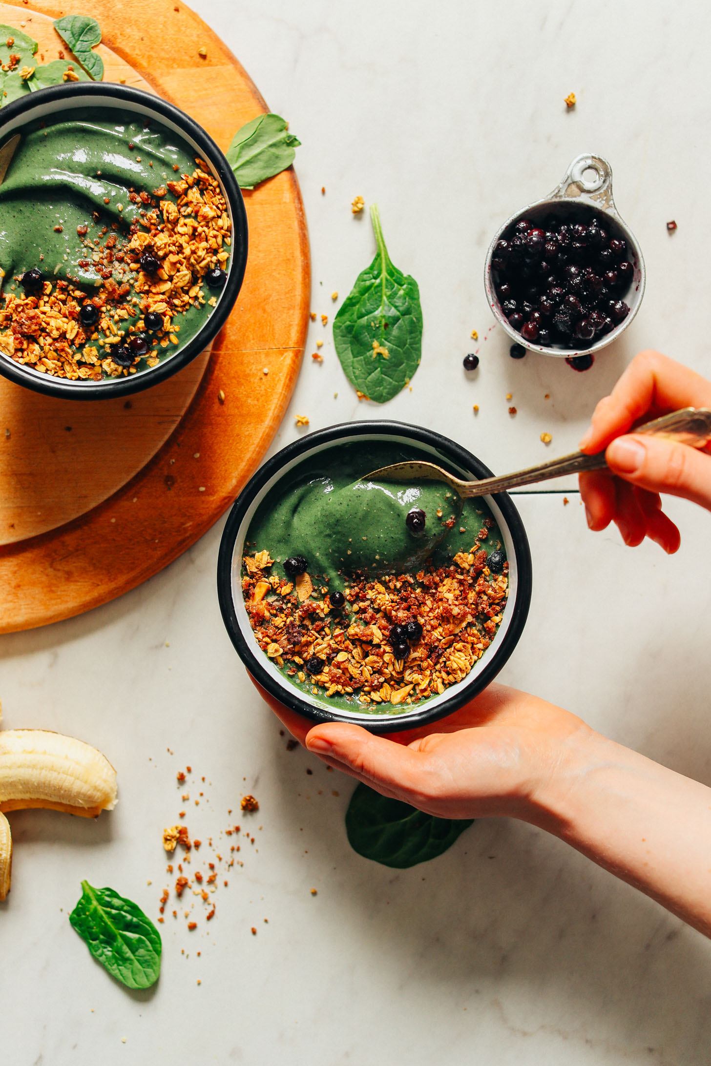 Grabbing a spoonful of our vegan Peanut Butter Banana Super Green Smoothie Bowl made with spirulina