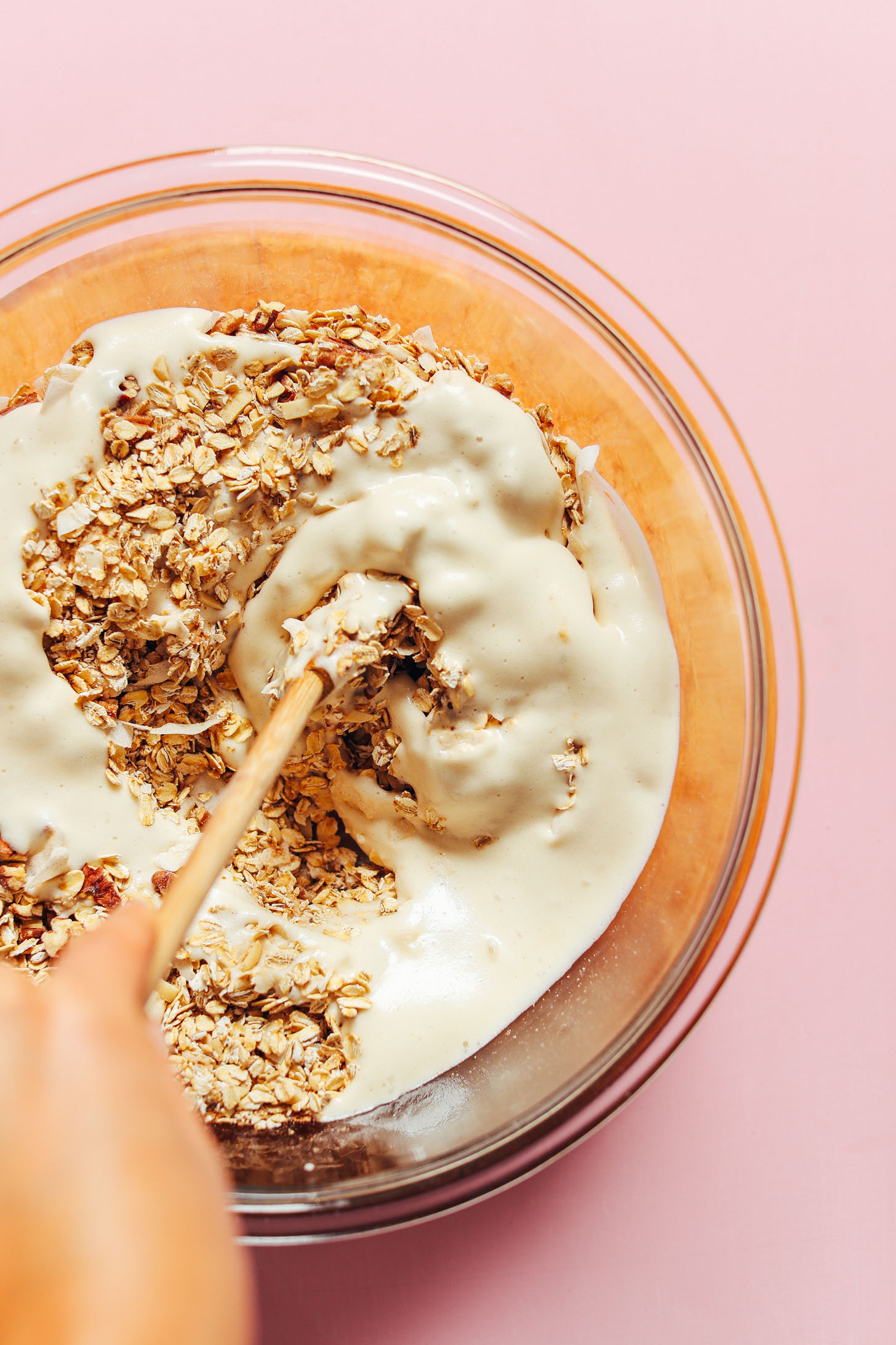 Stirring aquafaba into dry ingredients for crunchy naturally sweet oil-free granola