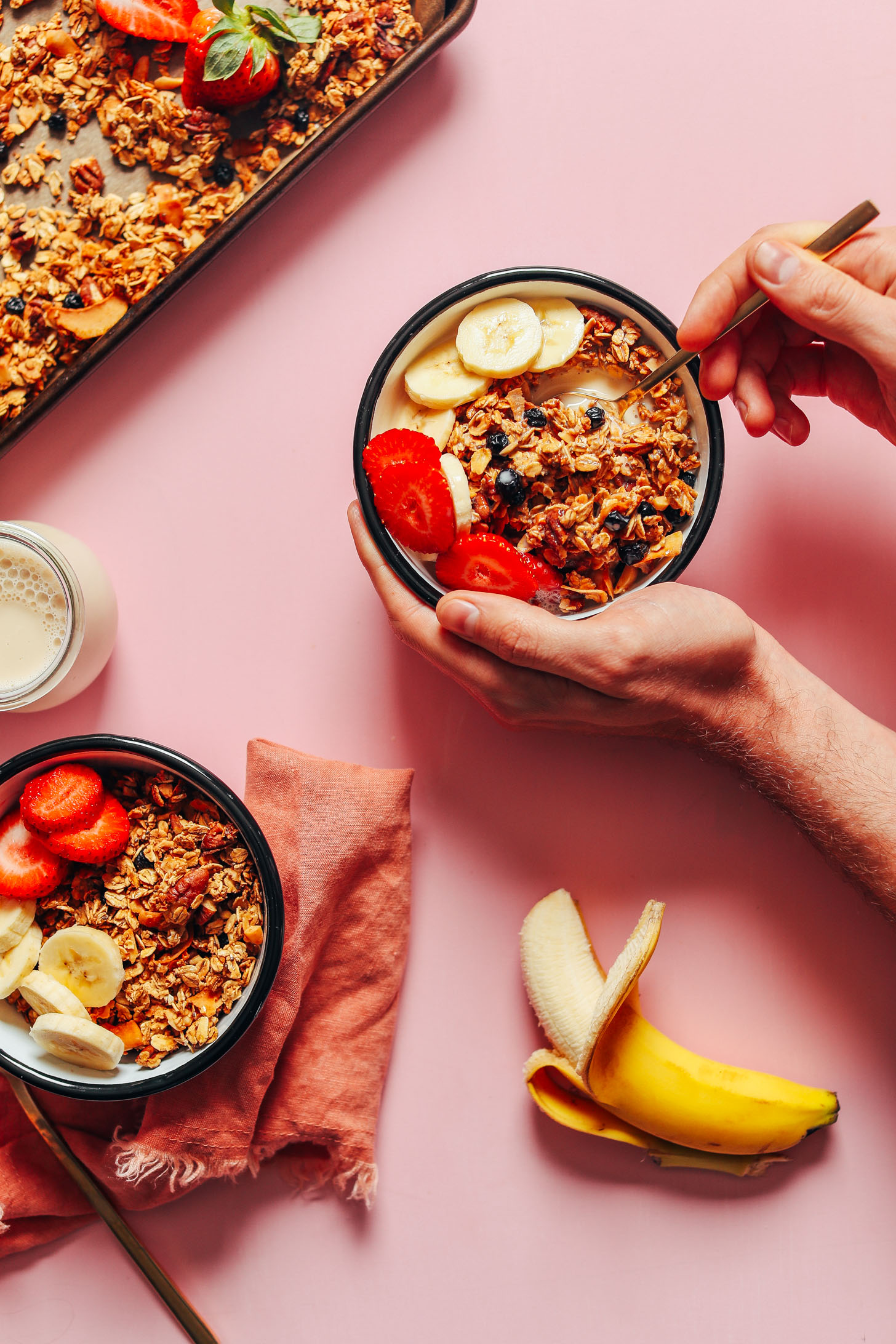 Using a spoon to grab a bite of granola for a gluten-free vegan breakfast