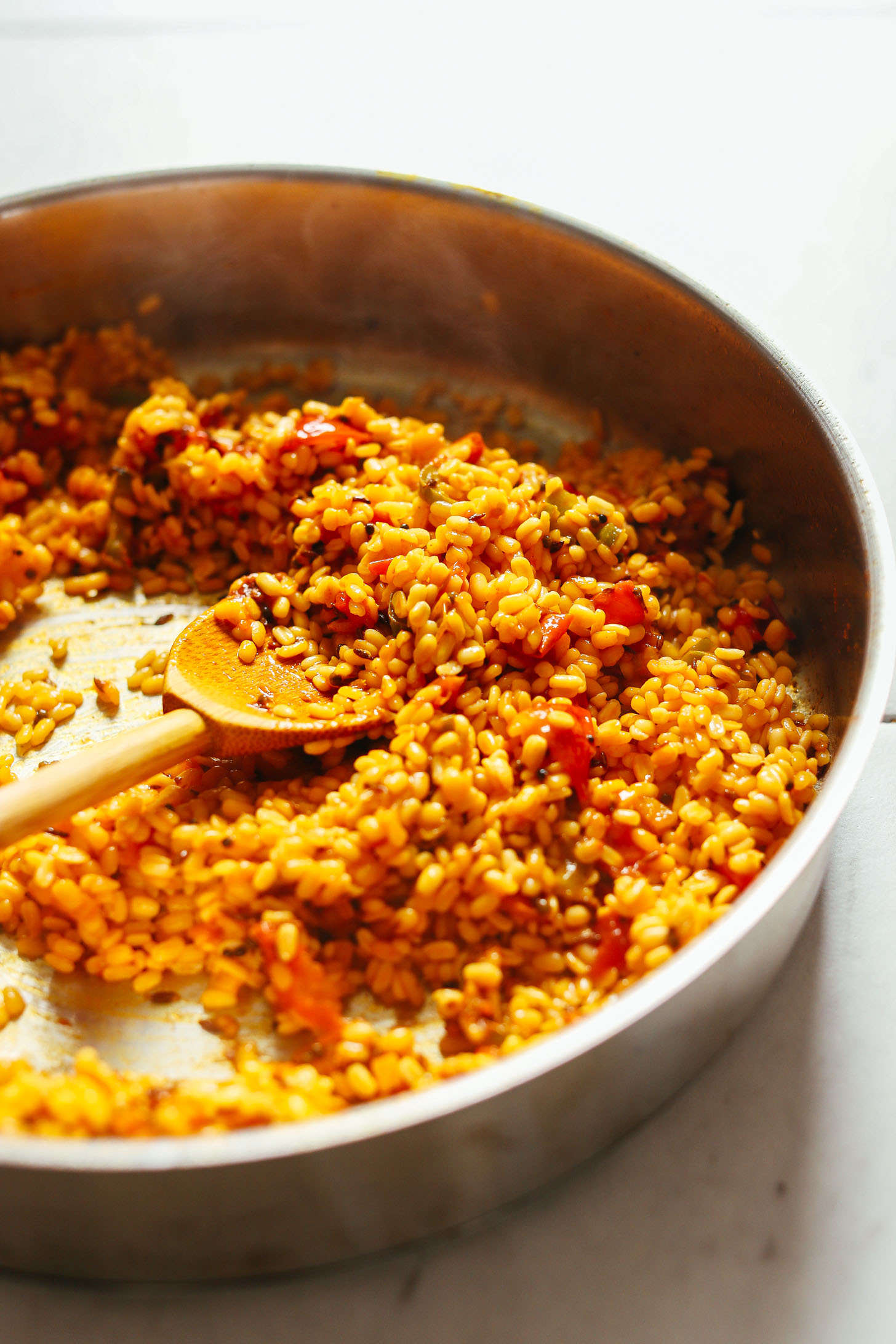 Stirring moong dal and tomato mixture for our gluten-free vegan kitchari recipe