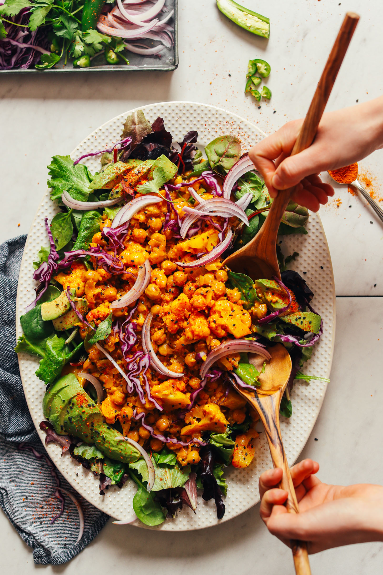 Grabbing a serving of our delicious Yellow Chickpea Cauliflower Curry over greens for a healthy plant-based dinner