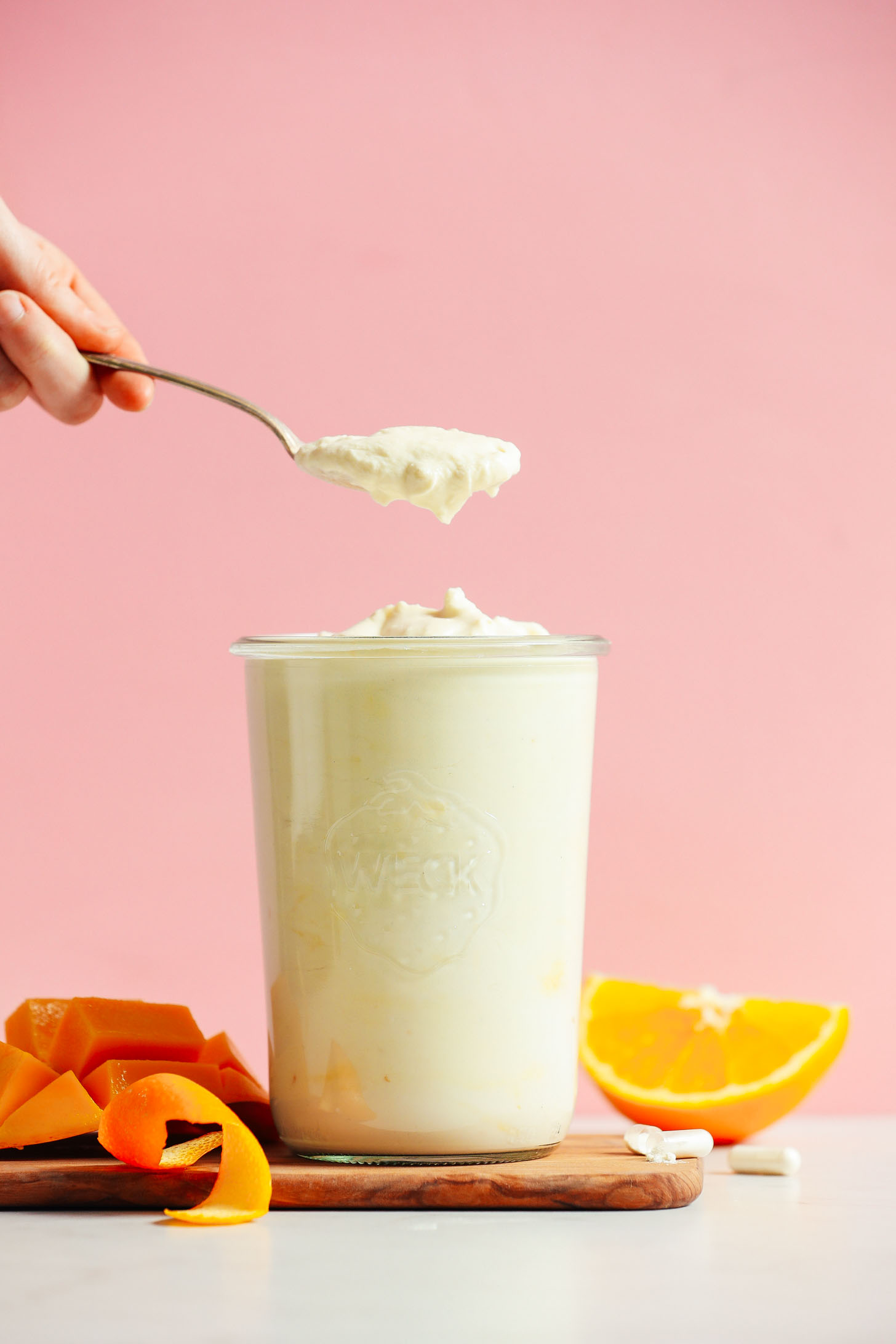 A big glass jar filled with our homemade Mango Coconut Yogurt recipe