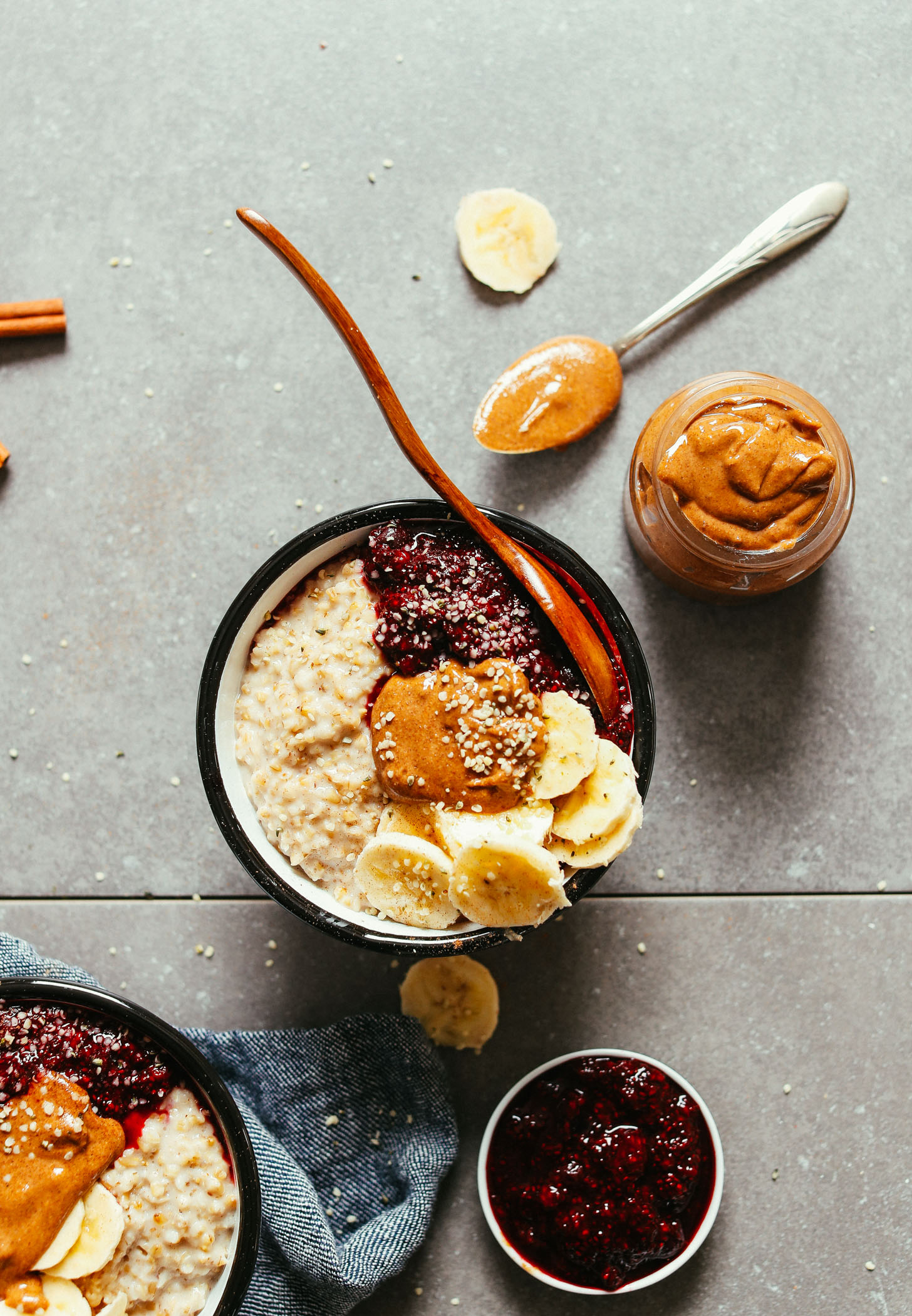 A bowl of perfect, fluffy steel cut oats topped with berries, banana, nut butter, and hemp seeds