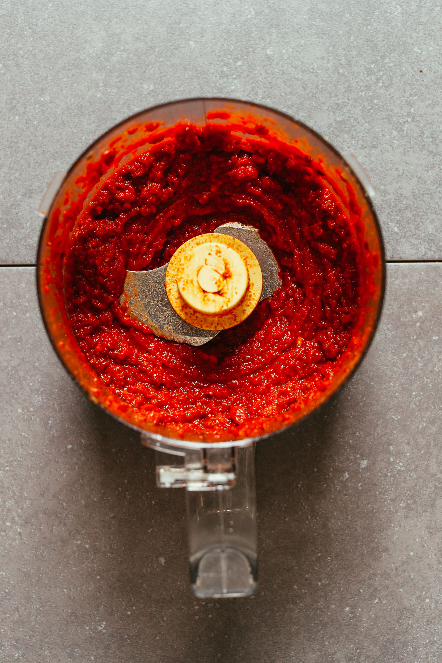 Food processor with freshly blended sun-dried tomatoes and spices for Vegan Taco "Meat"
