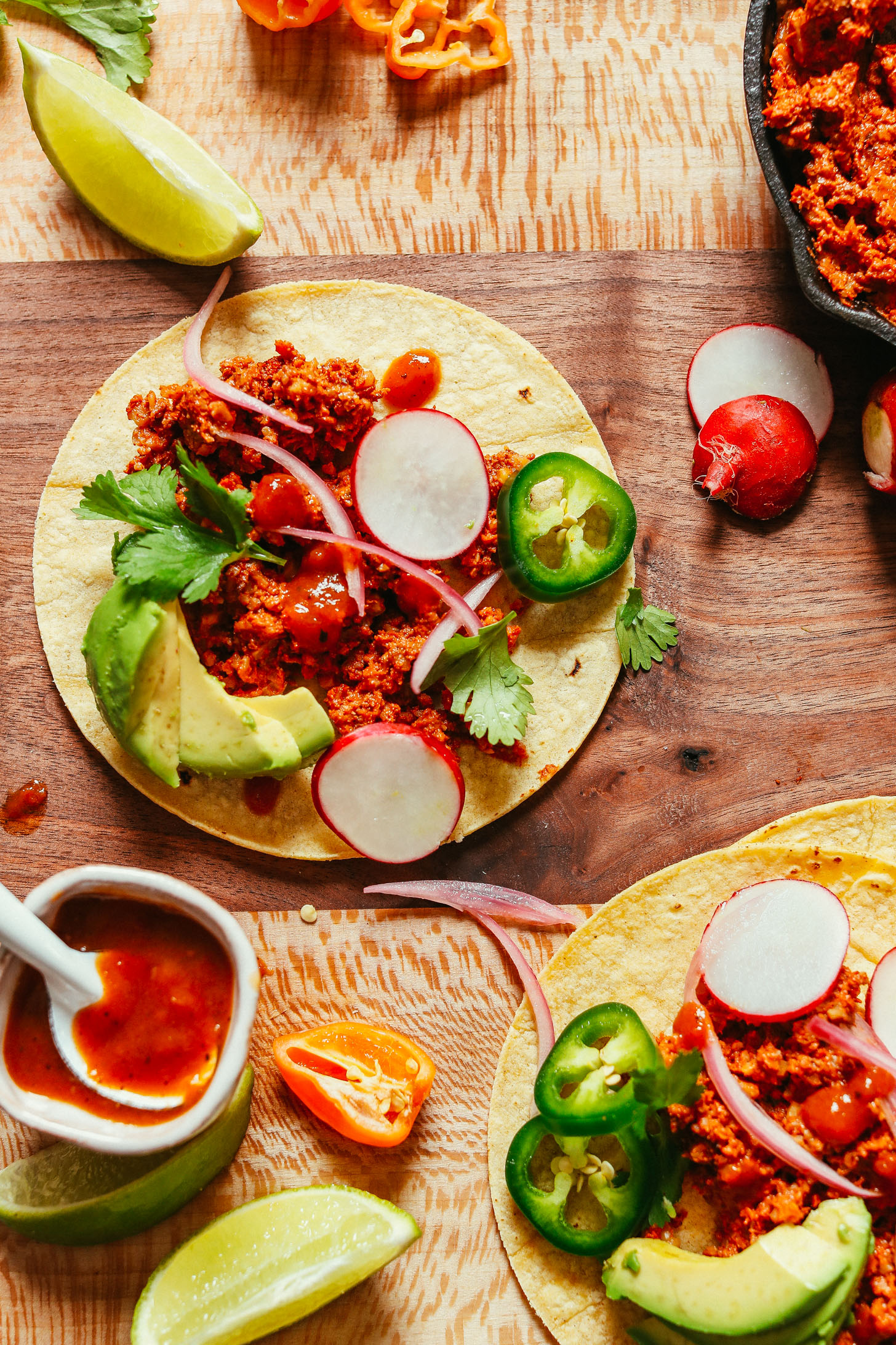 Corn tortillas topped with homemade Mexican Vegan Taco "Meat" and fresh vegetables