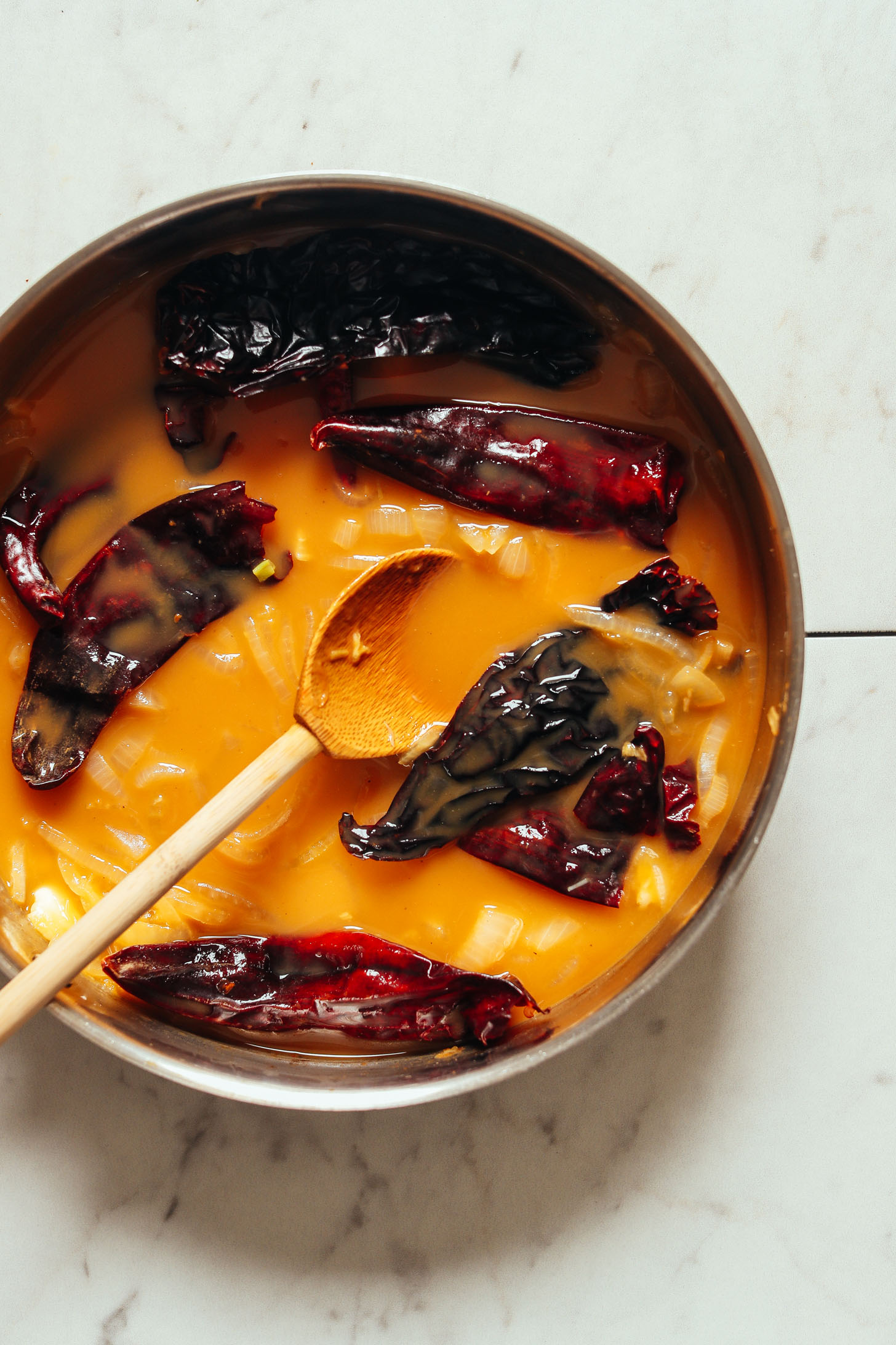 Making our homemade gluten-free vegan enchilada sauce recipe in a pan
